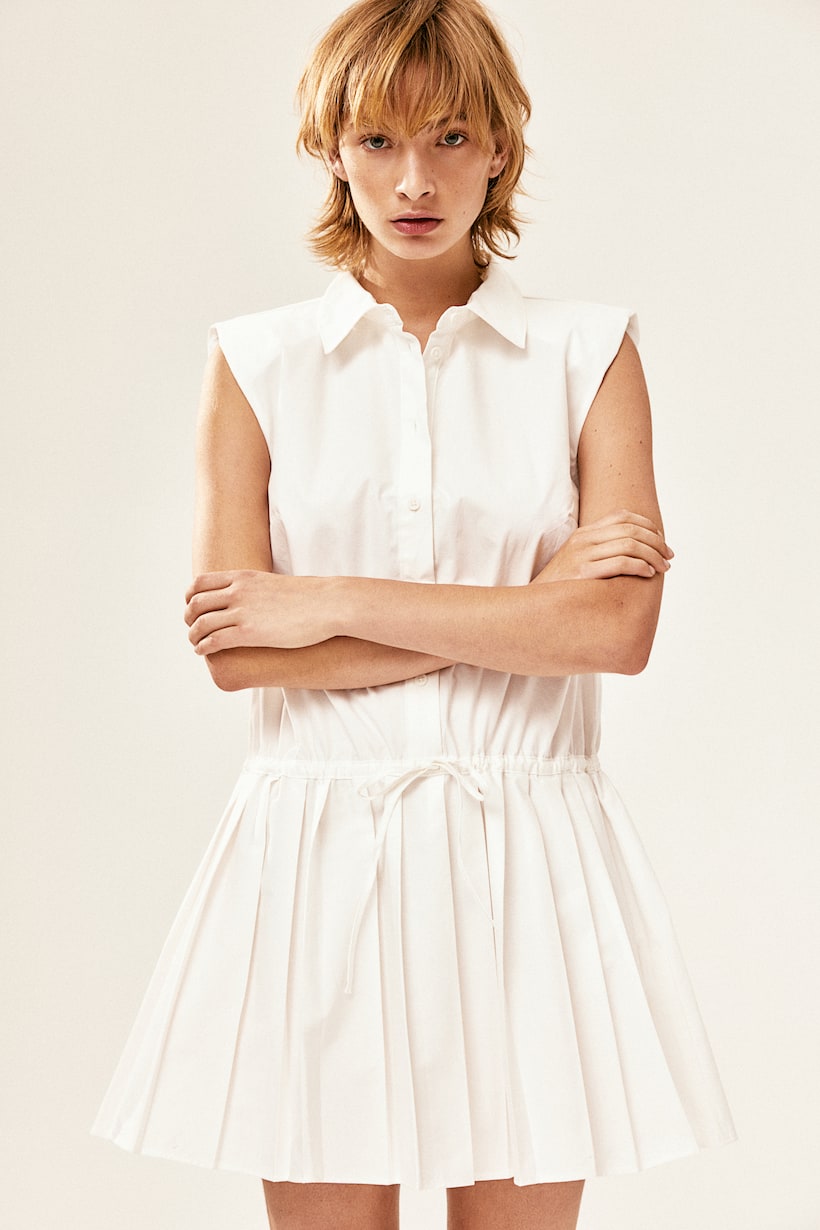 H&M cream Short, sleeveless dress in an airy cotton weave with a collar, shoulder pads and buttons at the top of the front. Narrow drawstring at the waist and a flared, pleated skirt. Unlined.