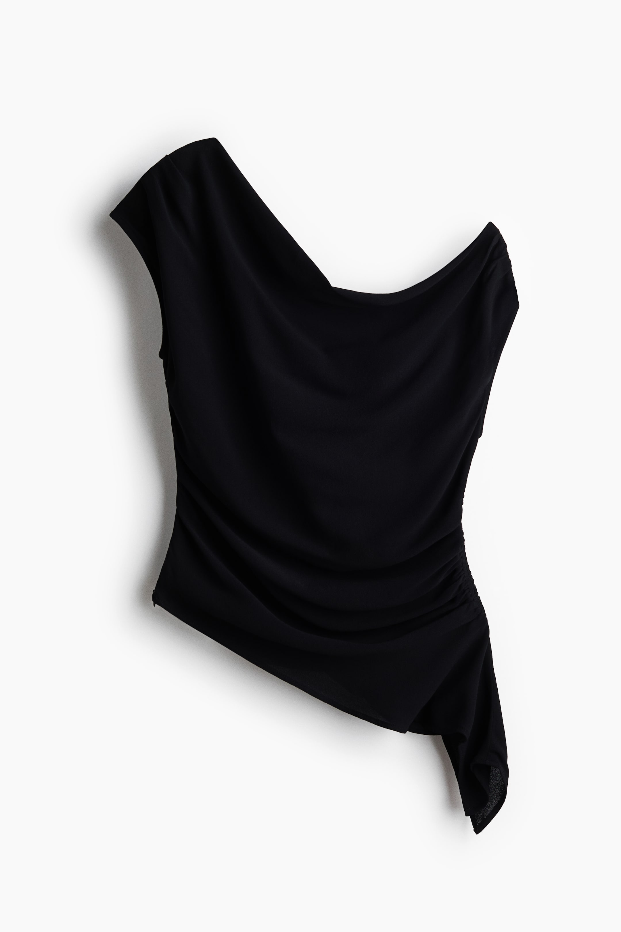 View larger image: A black fitted one-shoulder top is shown from the front, featuring an asymmetric neckline and a wide shoulder strap leading to a short sleeve panel. Gathered seams create a draped effect throughout the body, with a concealed zip visible along one side and an asymmetric hem.