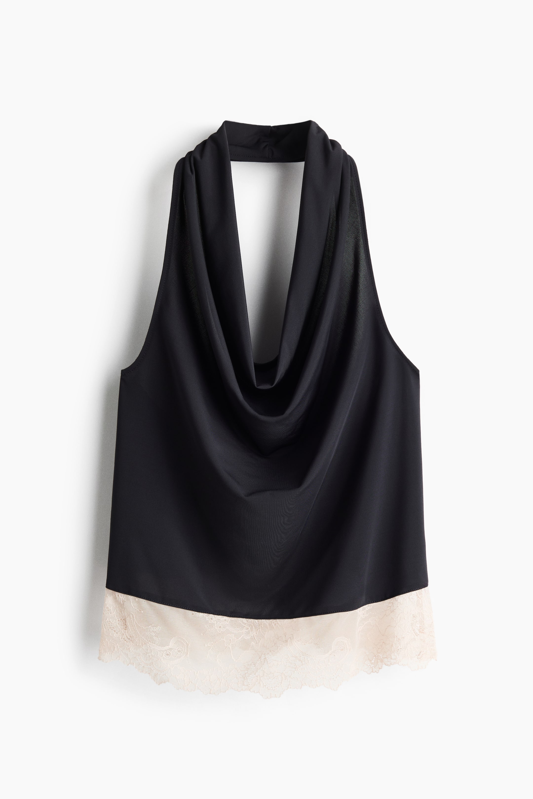 View larger image: This black halter top is shown front-facing, featuring a deep draped cowl neckline with a high halter band and a contrasting light cream scalloped lace trim along the straight hem.