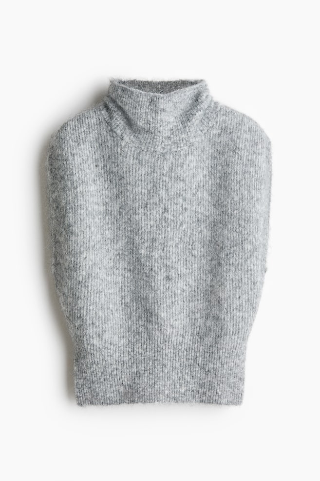 A grey knitted sleeveless jumper features a prominent ribbed pattern, a high polo neck, and a slightly fuzzy texture. - 1