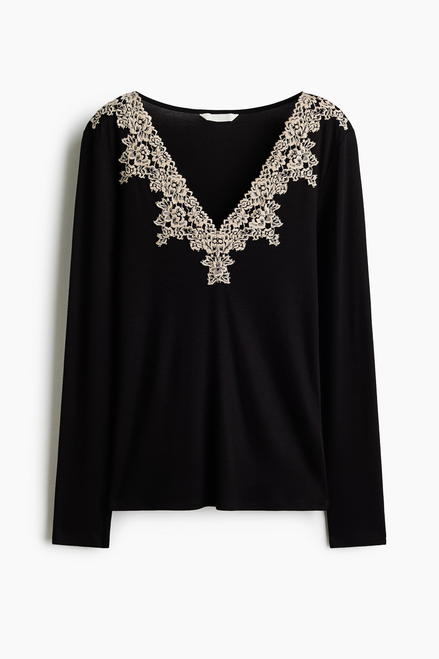 A black long-sleeved top features a V-neckline embellished with intricate beige lace trim extending over the shoulders, shown from a front-facing angle.