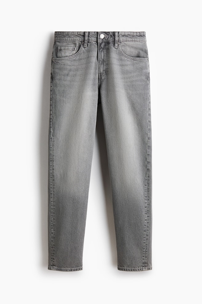 Grey 5-pocket jeans shown from the front, hanging vertically. They feature a regular waist with a button closure and a zip fly. The jeans have a faded wash, a regular fit with a looser feel through the leg and a tapered leg. - 1