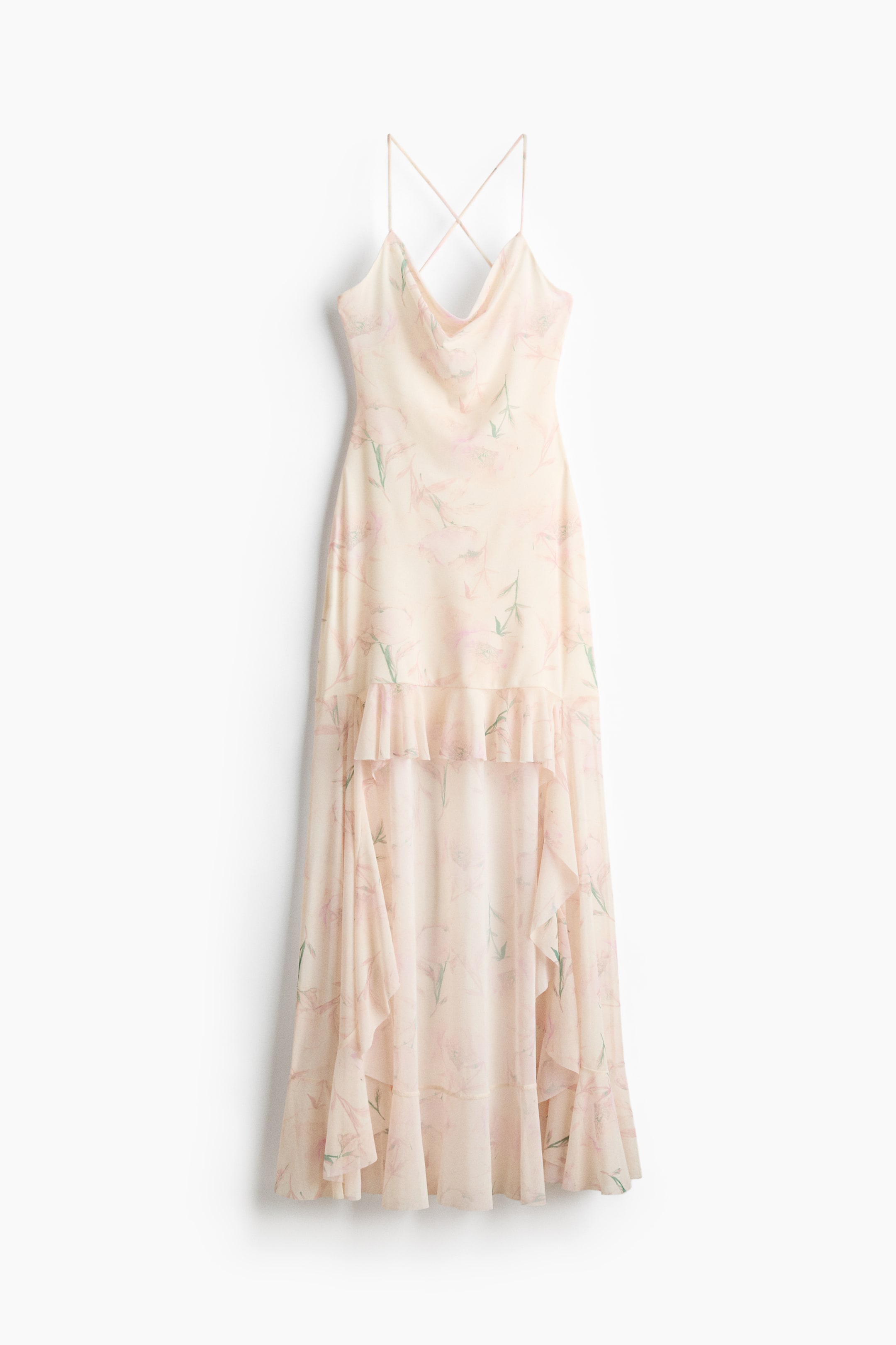 View larger image: A cream maxi slip dress featuring a pink and green floral print. Designed with thin criss-cross straps, a cowl neckline, and a tiered ruffled skirt forming an asymmetrical high-low hem.