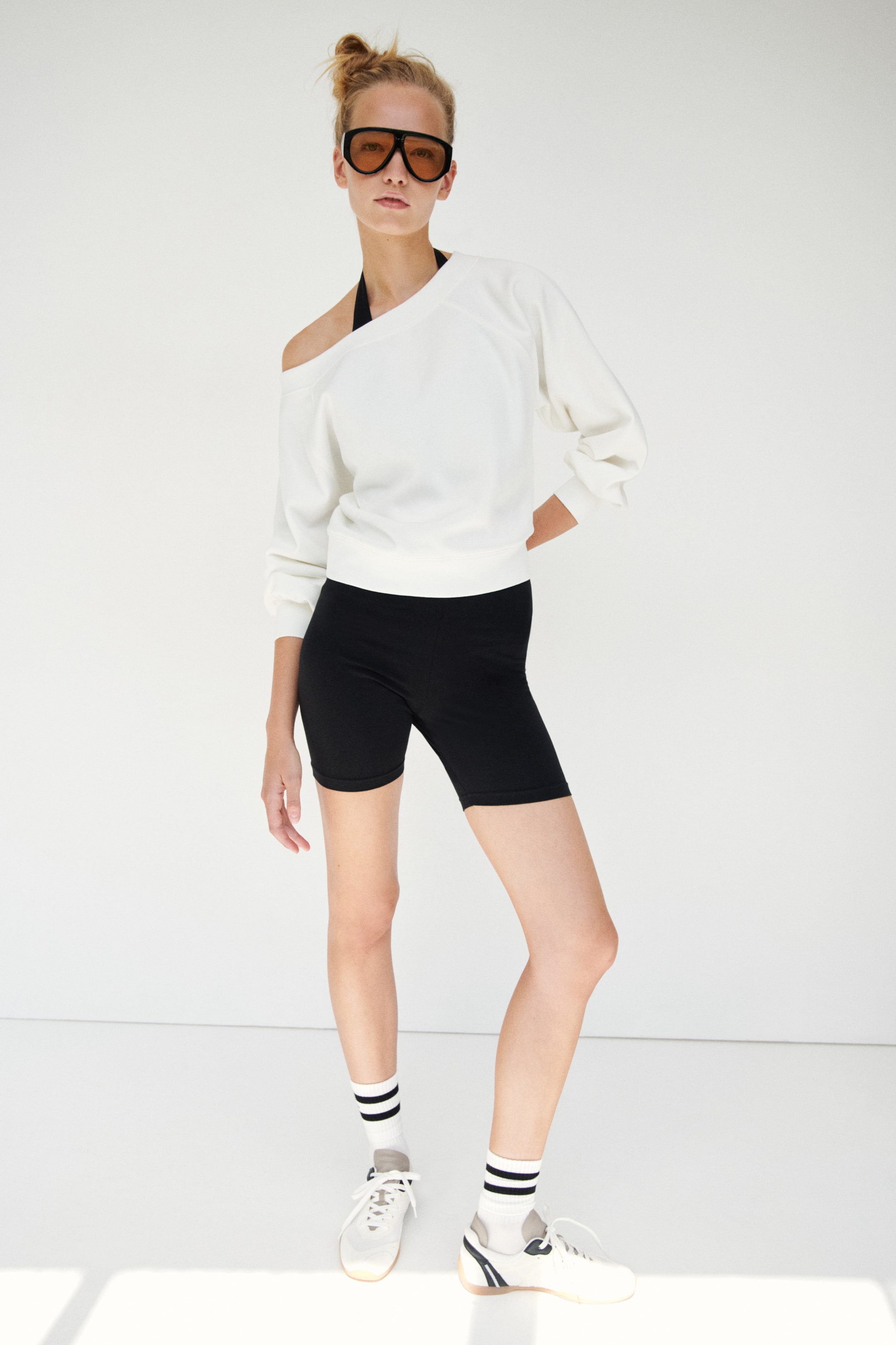 View larger image: A loose-fit off-the-shoulder top in white sweatshirt fabric is being showcased from the front, featuring a ribbed top edge, long raglan-cut balloon sleeves with ribbed cuffs, and a ribbed hem.