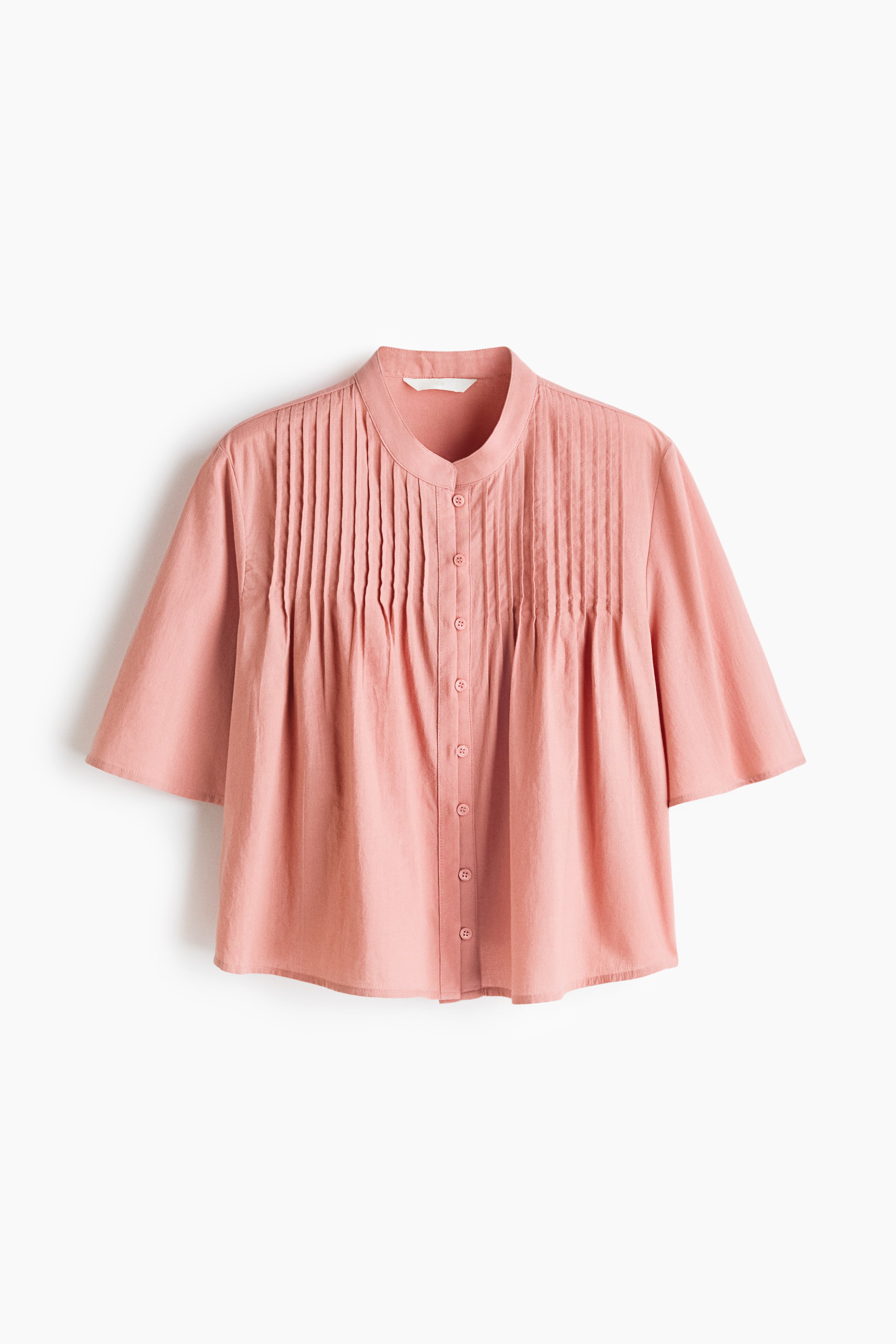 View larger image: The image showcases a pink blouse from the front, highlighting a band collar, vertical pintucks running down the bodice, elbow-length flared sleeves, and a full button-front closure with matching pink buttons.
