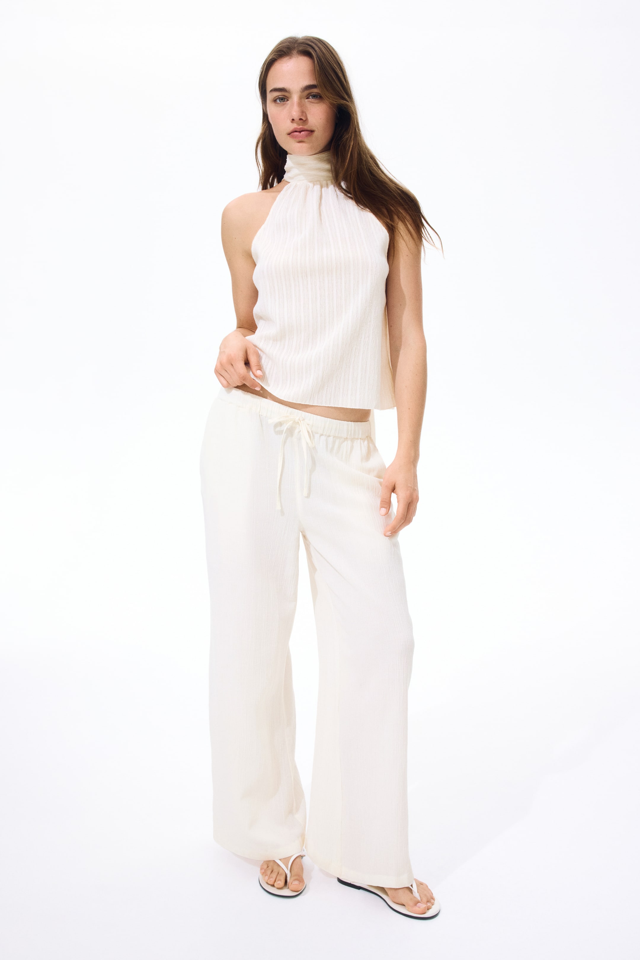 View larger image: Trousers crafted from a crinkled linen blend weave, showcasing an elasticated, drawstring waist and straight legs, as viewed from the front.