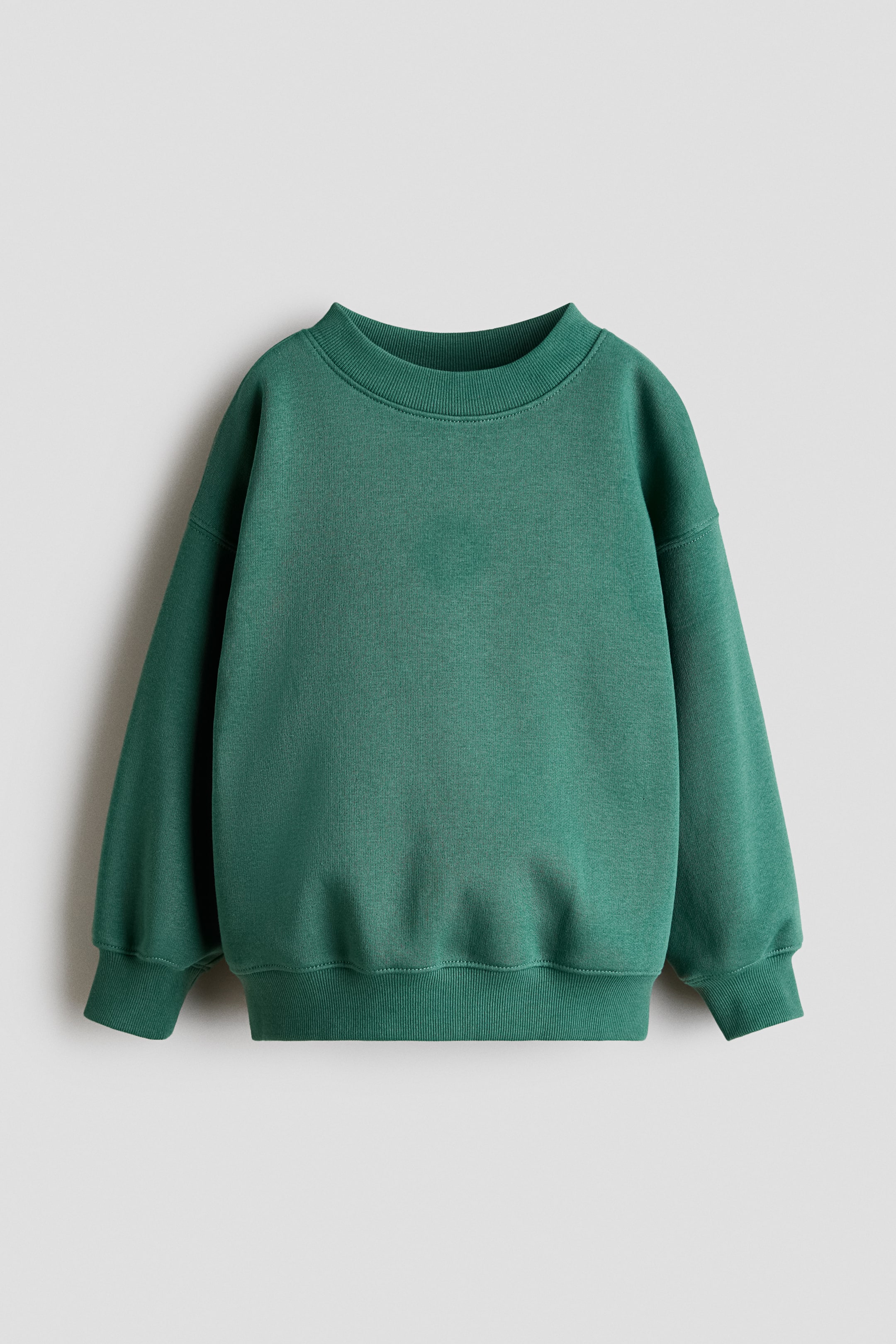 View larger image: The green sweatshirt is displayed from the front, showcasing a round ribbed neckline, long sleeves with ribbed cuffs, and a ribbed hem.