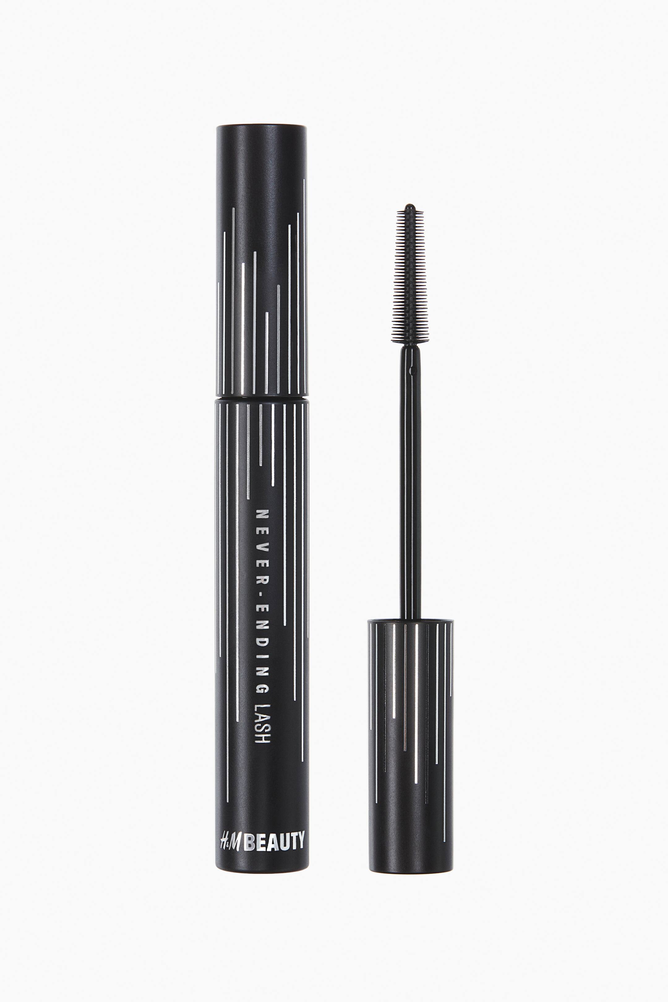 View larger image: A black mascara is being displayed, featuring a cylindrical matte black tube and its detached wand. The tube's front is decorated with white vertical line patterns and 'NEVER-ENDING LASH' text, with the 'H&M BEAUTY' logo at the bottom, while the matching black wand is showing a slender brush with short, comb-like bristles.