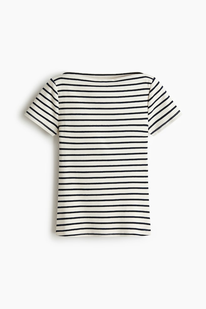 A short-sleeved top is displaying a cream base with navy blue horizontal stripes, presented in a front view. It is featuring a boat neck, short sleeves, and a subtle ribbed knit texture. - 1