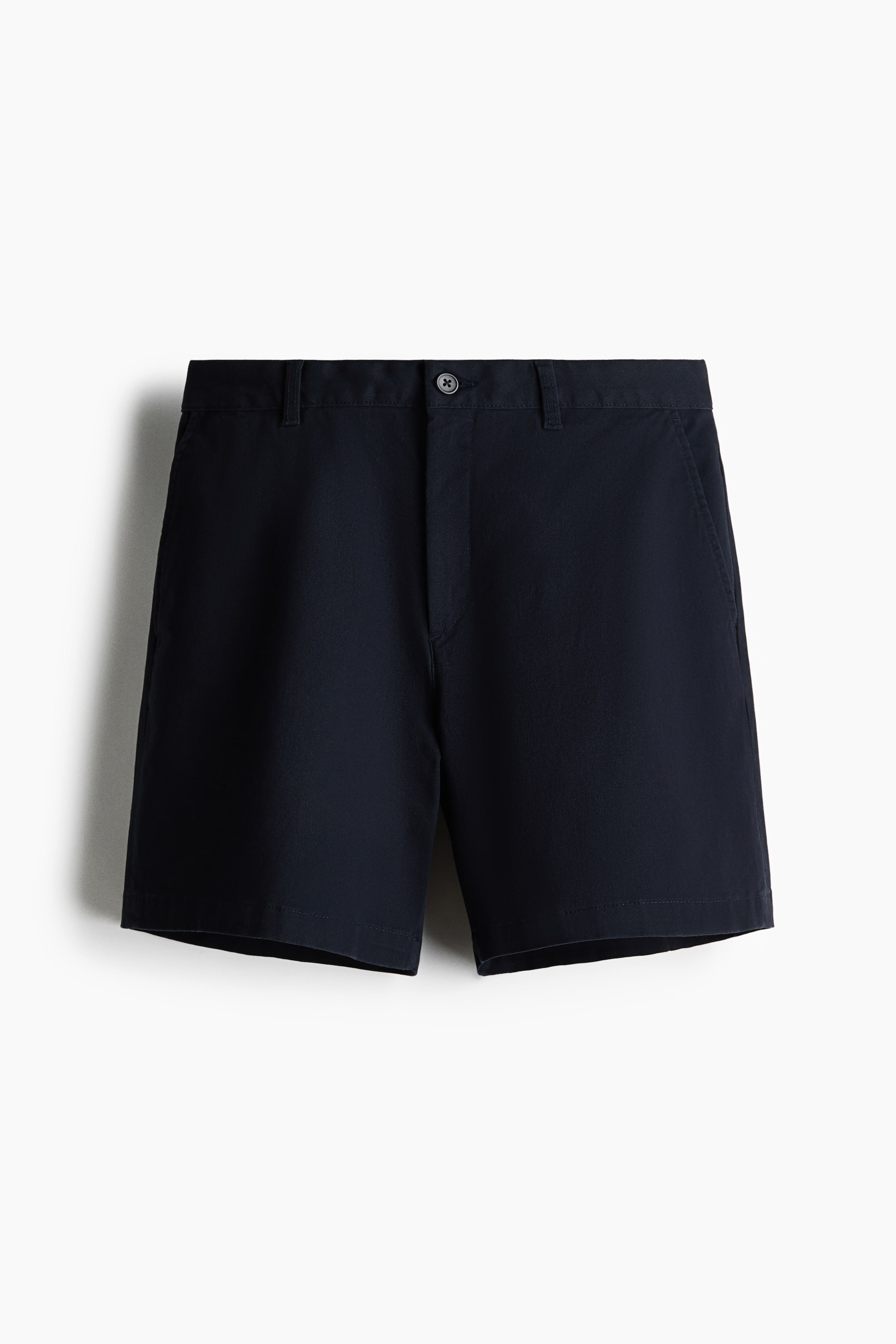 View larger image: The navy shorts are shown from the front, featuring a waistband with belt loops, a single-button closure, and a fly placket. They are designed with two front slash pockets, a straight leg, and hemmed cuffs.