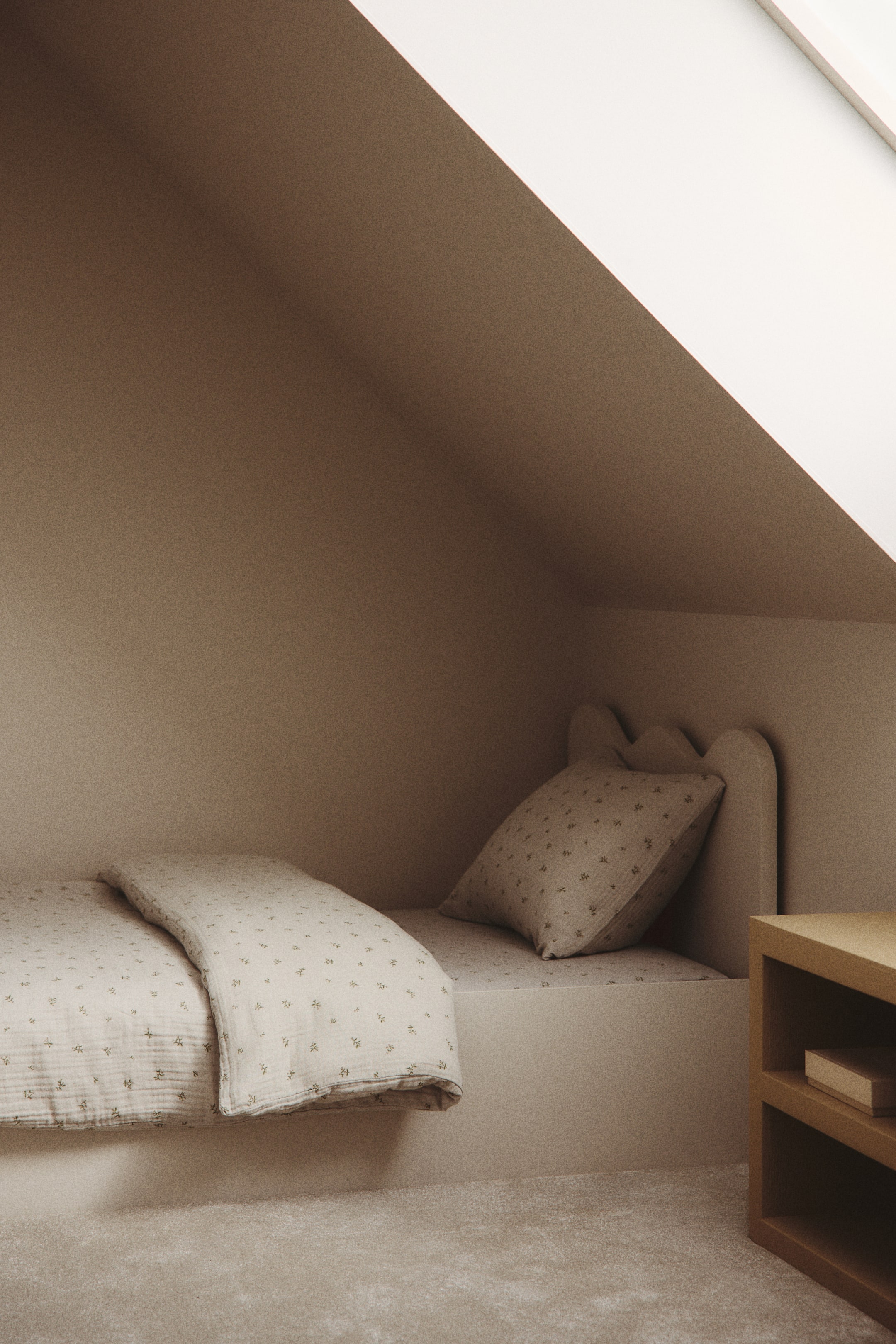 View larger image: A duvet cover set in soft cotton muslin is showcased on a bed, featuring a light, neutral color with a subtle all-over print of small, scattered floral motifs. The duvet cover is elegantly draped over the mattress, and a matching pillowcase is propped against the headboard, both highlighting the same textured fabric and print.