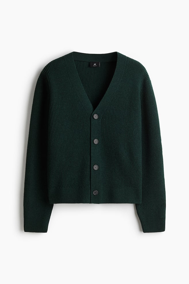 A dark green, rib-knit cardigan is displayed FRONT, featuring a deep V-neck and five dark gray buttons fastening down the front. It is designed with long sleeves and is cut in a regular fit. - 1