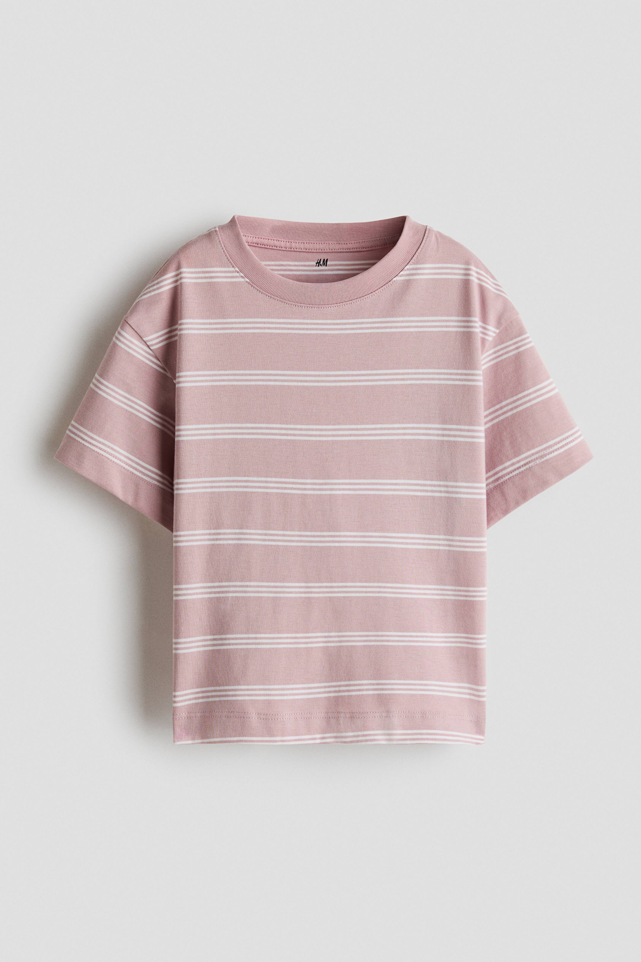 View larger image: A dusty pink t-shirt is shown from the front, featuring a relaxed fit with horizontal white stripes in a double-line pattern. The garment showcases a ribbed crew neck, dropped shoulders, and short sleeves.