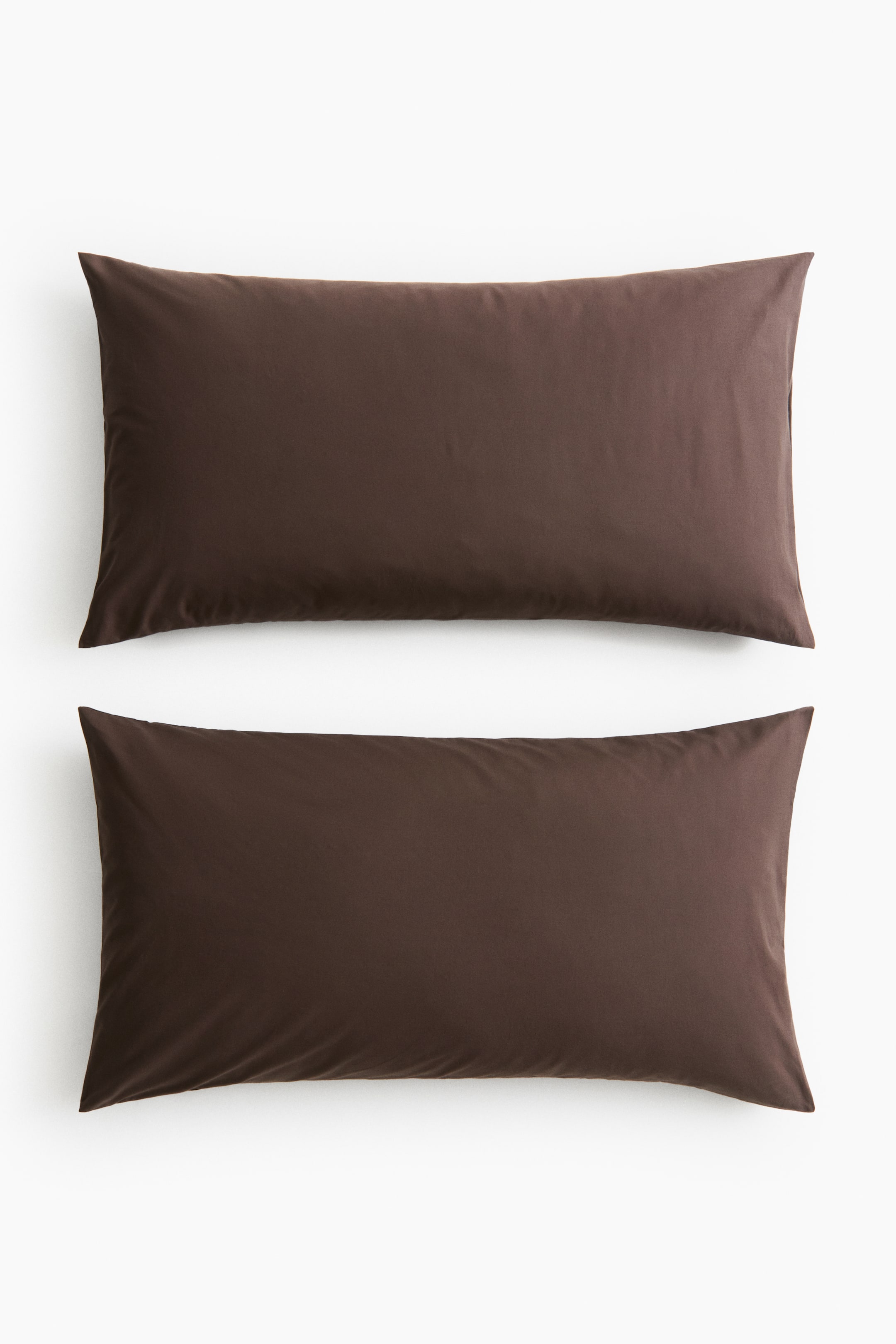 View larger image: A pair of rectangular brown pillowcases showcases their smooth, soft cotton weave texture from the front. Each pillowcase features an envelope opening.