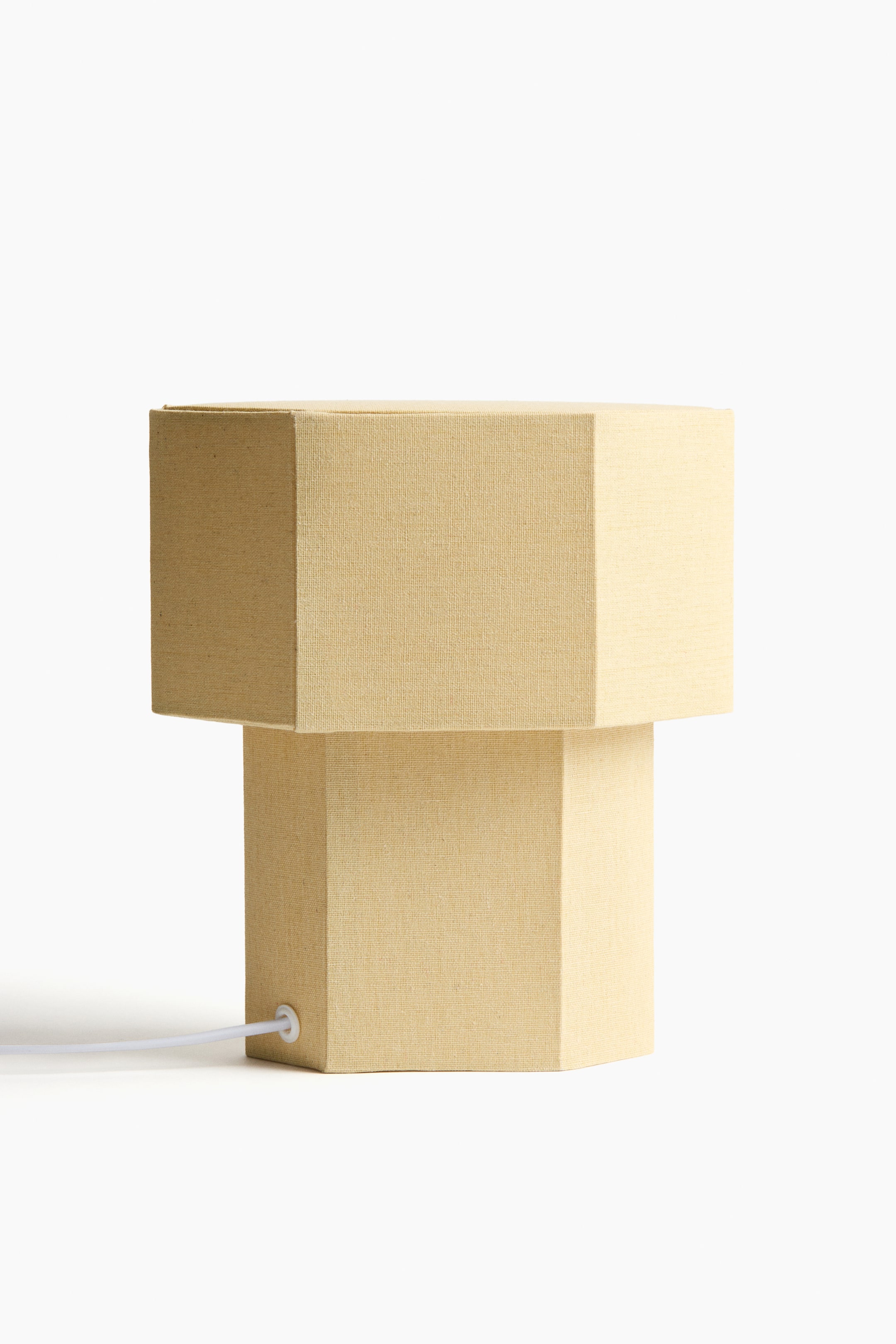 View larger image: The wider top section is resting on a narrower octagonal base, with a white power cord emerging from its lower side.