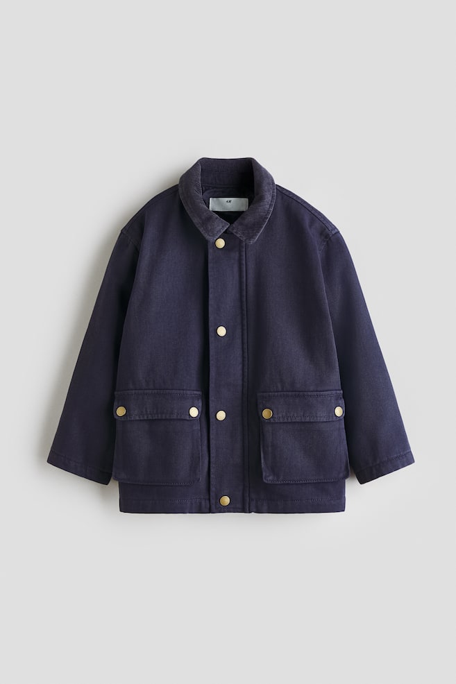 A dark blue jacket is facing forward, featuring a dark blue corduroy collar and a front placket with gold-toned snap fasteners. Two large patch pockets are visible on the lower front, each with a flap secured by a gold-toned snap fastener. - 1