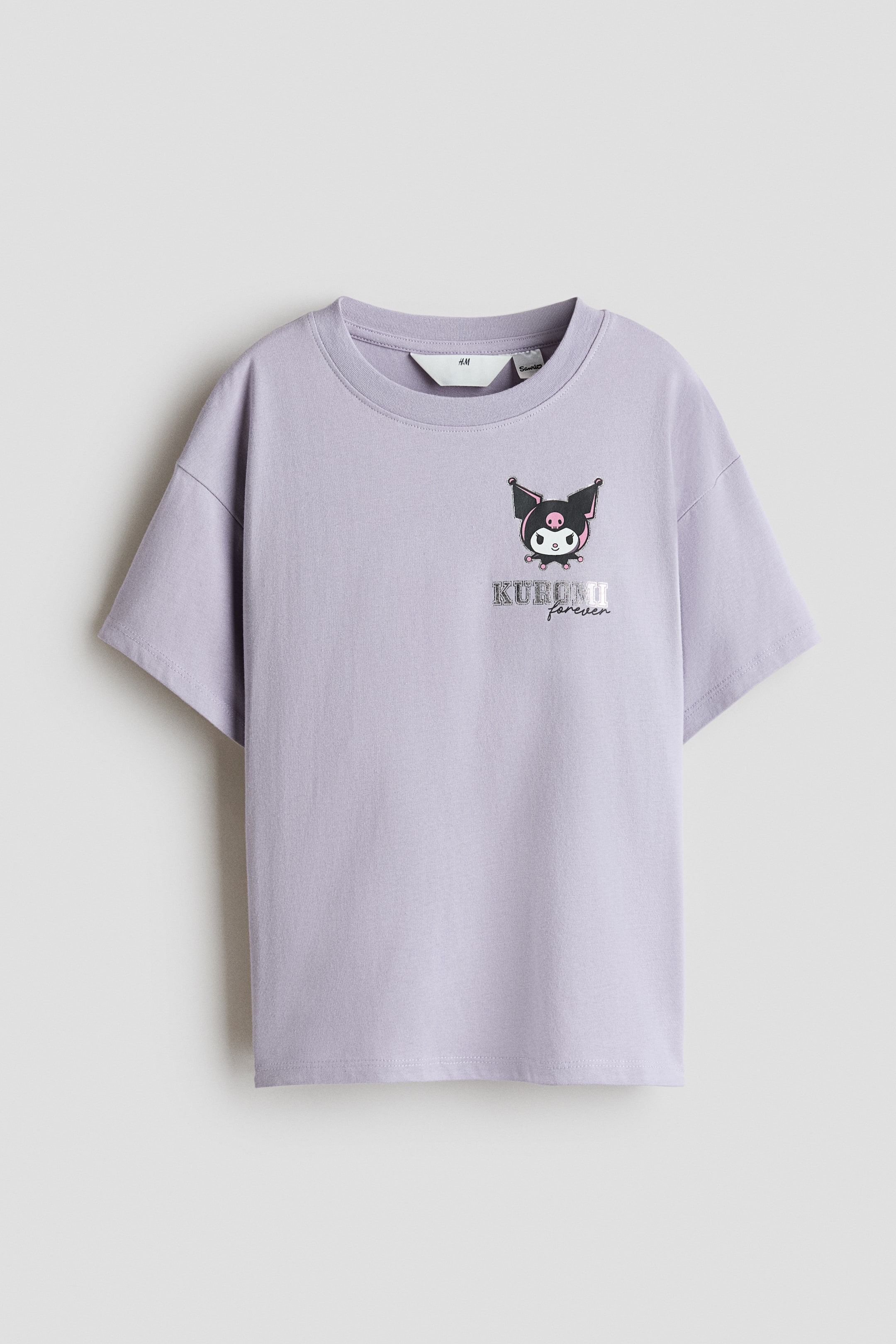 View larger image: A light purple cotton T-shirt is shown from the front, featuring a round neckline, dropped shoulders, and short sleeves. The front displays a small graphic of the character Kuromi with the text "KUROMI forever" on the left chest.