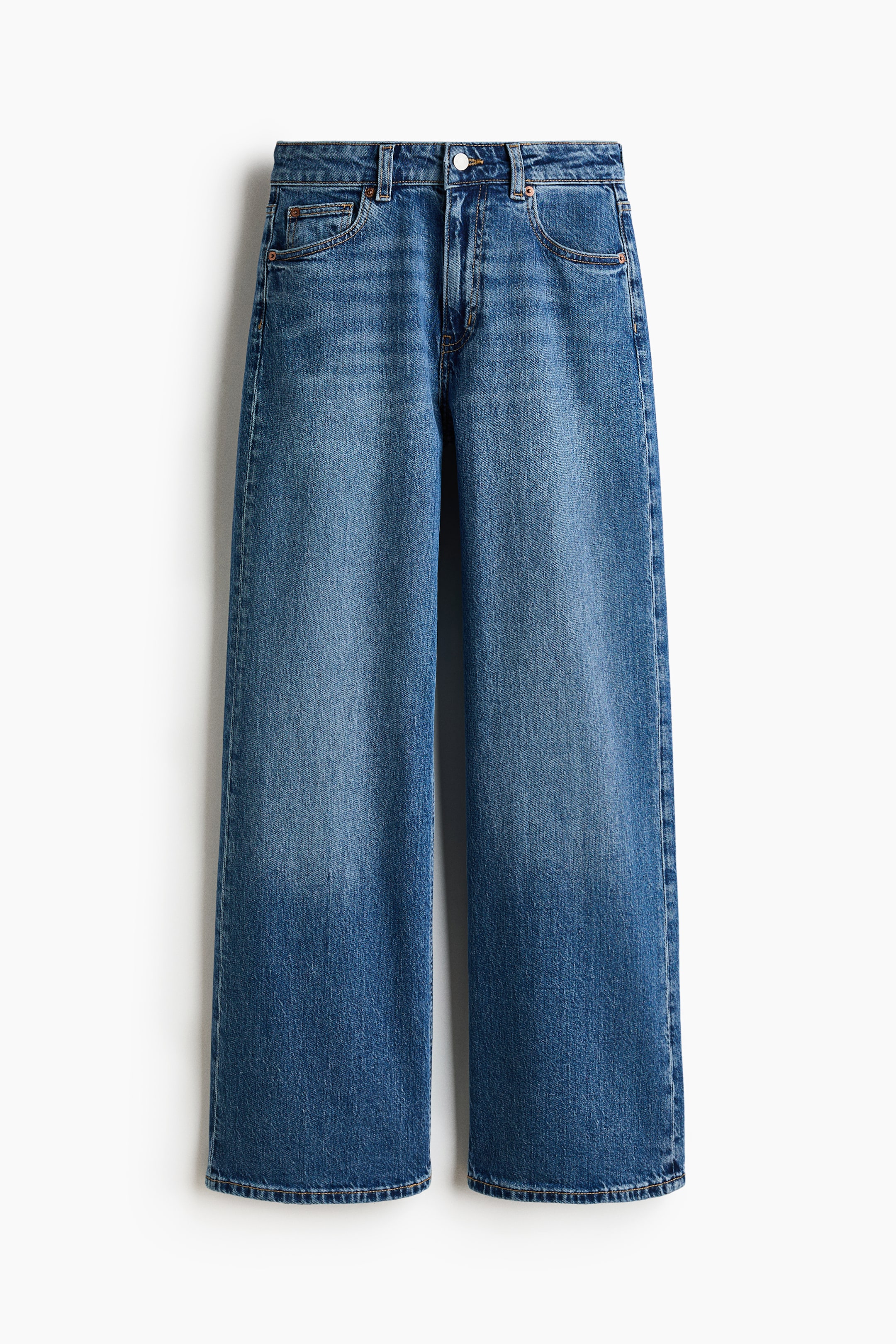 View larger image: 5-pocket blue denim jeans are shown from the front, featuring a high waist with a zip fly and button closure. The jeans display a regular fit from the waist to the hip and a wide cut from the thigh to the hem, with their regular length appearing to hit the top of the foot.