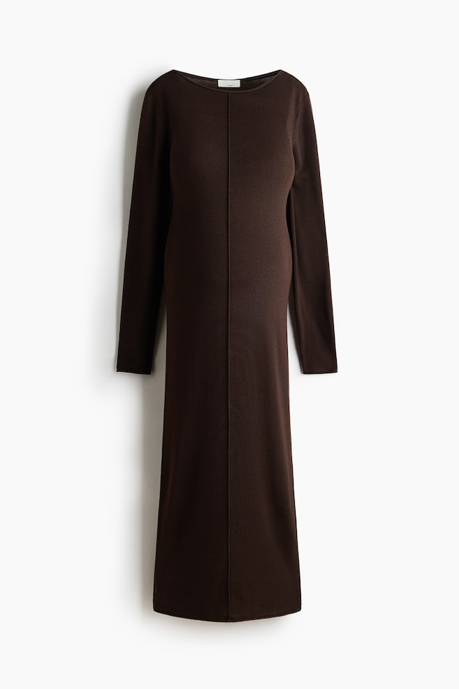A dark brown knit dress is presenting from the front, featuring a boat neck and long sleeves. A vertical seam is running down the center front, extending to a maxi length. - 1