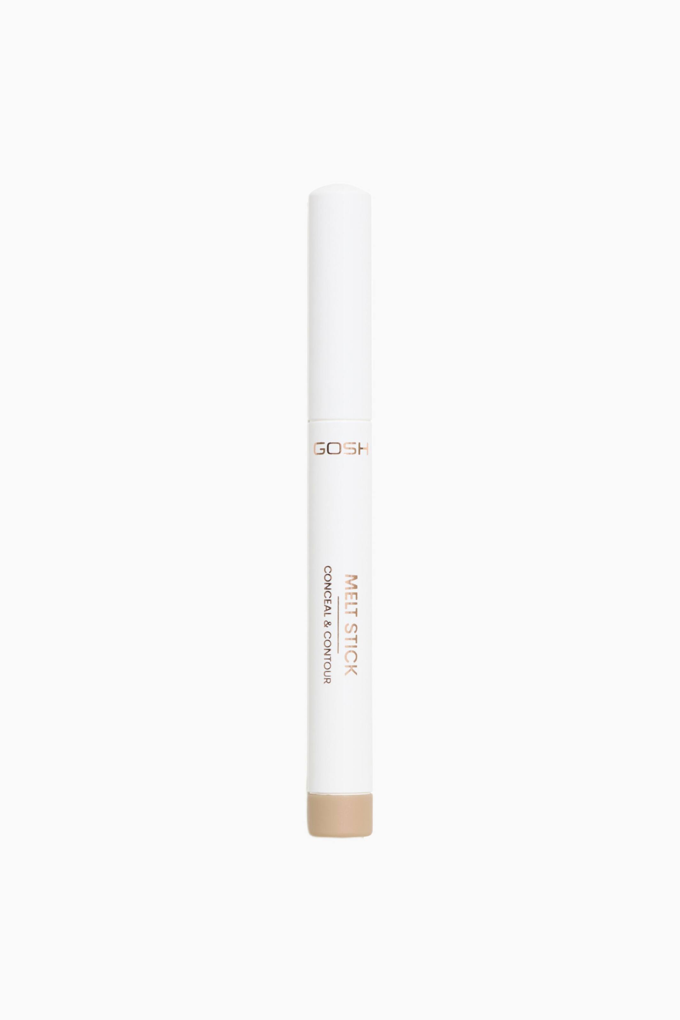 Visa större bild: Melt Stick Conceal & Contour står upprätt och har ett smalt, cylindriskt vitt hölje med matchande lock. Den visar roséguldfärgad märkning med texten "GOSH" och "MELT STICK CONCEAL & CONTOUR" vertikalt längs sidan, medan en beige tonad spets syns vid den nedre basen.