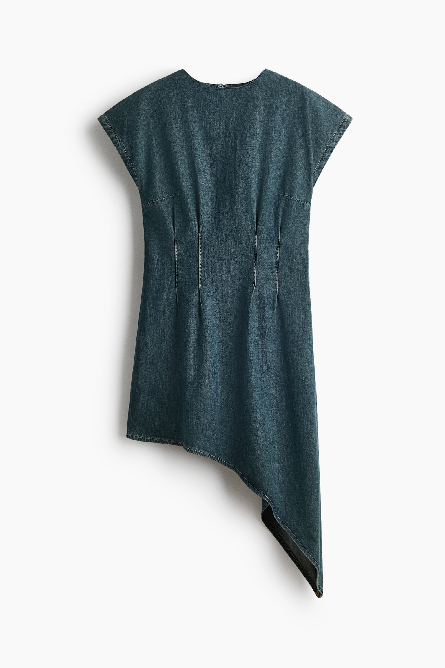 A dark wash denim dress is shown from the front, displaying a structured silhouette with a round neckline, cap sleeves, and vertical waist darts. The dress features a dramatic asymmetrical hemline that slopes sharply downward on the right side.