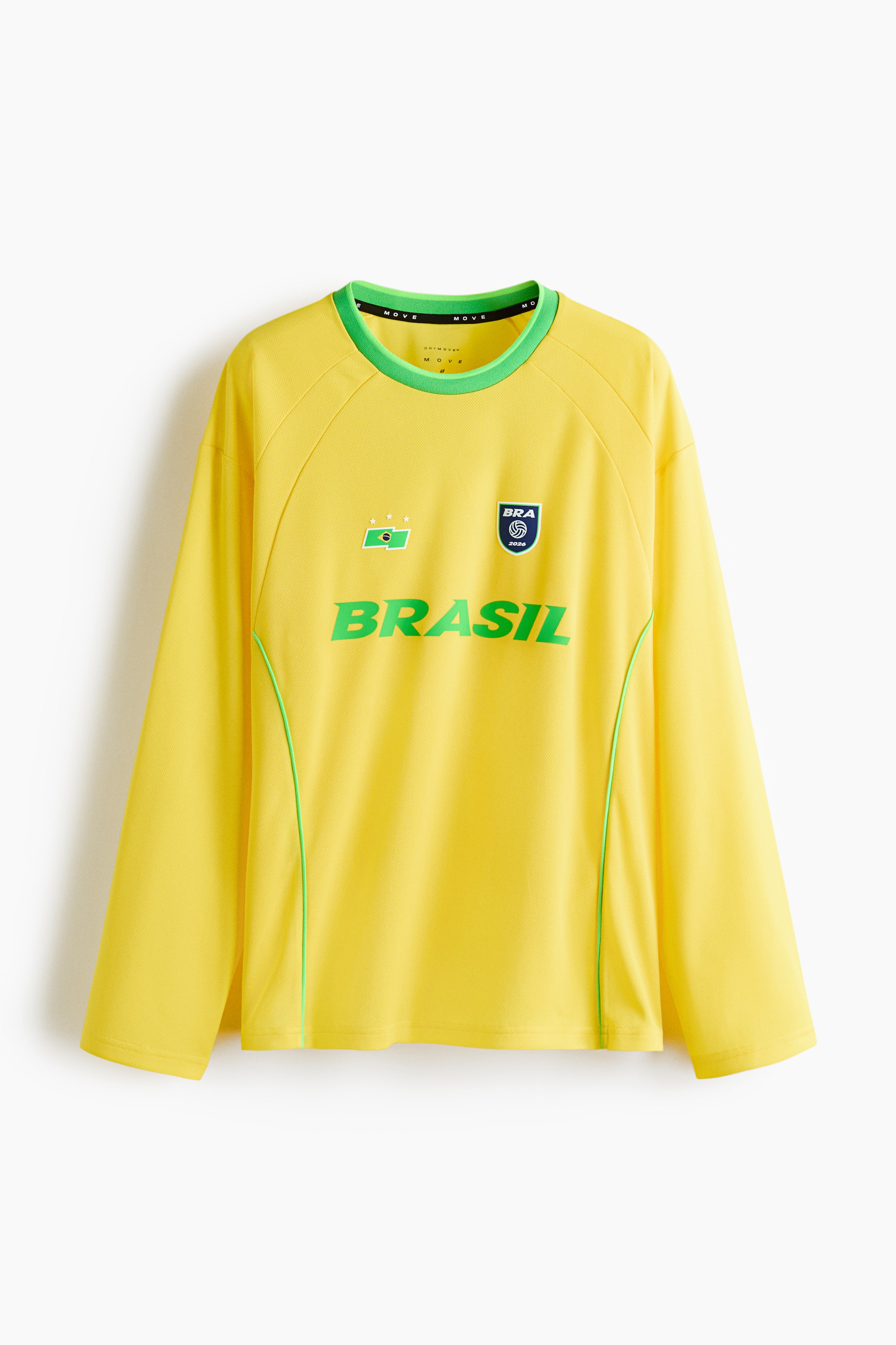 View larger image: A yellow long-sleeve shirt features a green-trimmed round neck and green piping running vertically down the front sides. The chest displays "BRASIL" in large green letters, accompanied by a green and white flag emblem with three stars on the left, and a blue and white circular emblem with "BRA 2024" and a soccer ball graphic on the right.