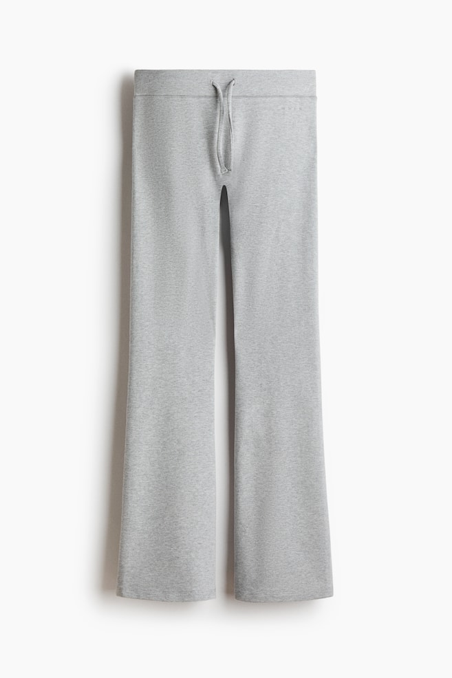 Light grey marl lounge pants are hanging front-facing, featuring a flat waistband with an adjustable matching drawstring at the centre. The trousers fall into a relaxed, wide-leg silhouette with clean-finished hems. - 1