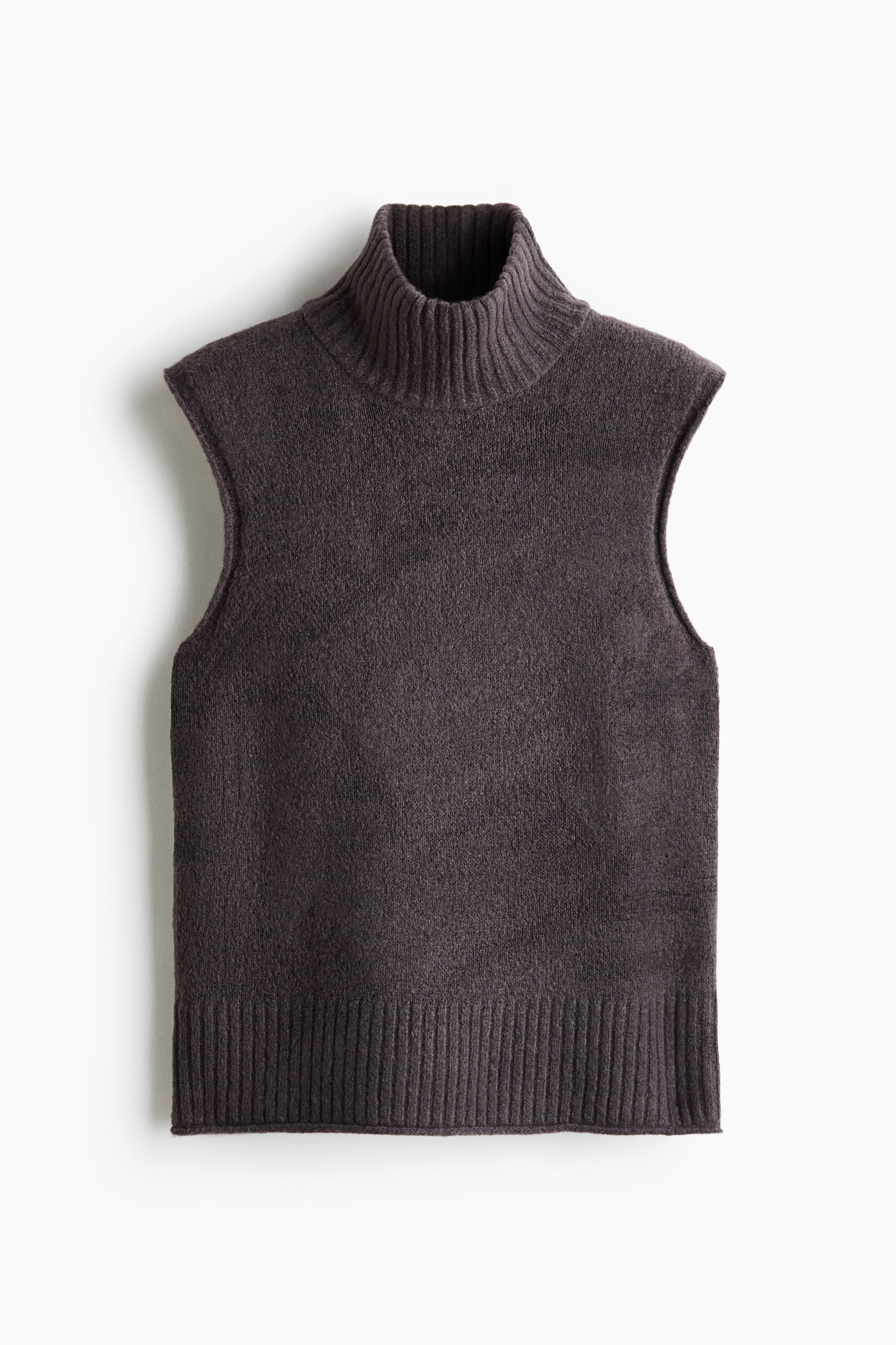 View larger image: A dark grey knit vest is facing front, showcasing its soft textured fabric, high ribbed neck, and sleeveless design with rolled edges. The vest features a straight silhouette with a wide ribbed trim at the hem.