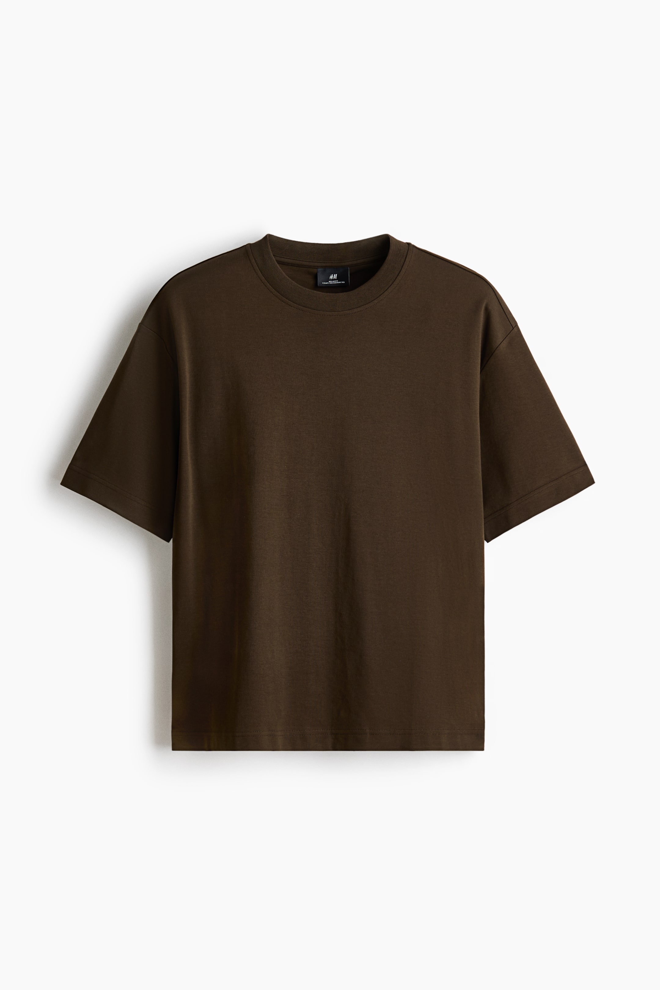 View larger image: A dark brown T-shirt is shown from the front. It features a crew neck, short sleeves, and a straight hem. A small black label is visible on the inner back neckband, and the T-shirt has a relaxed fit.