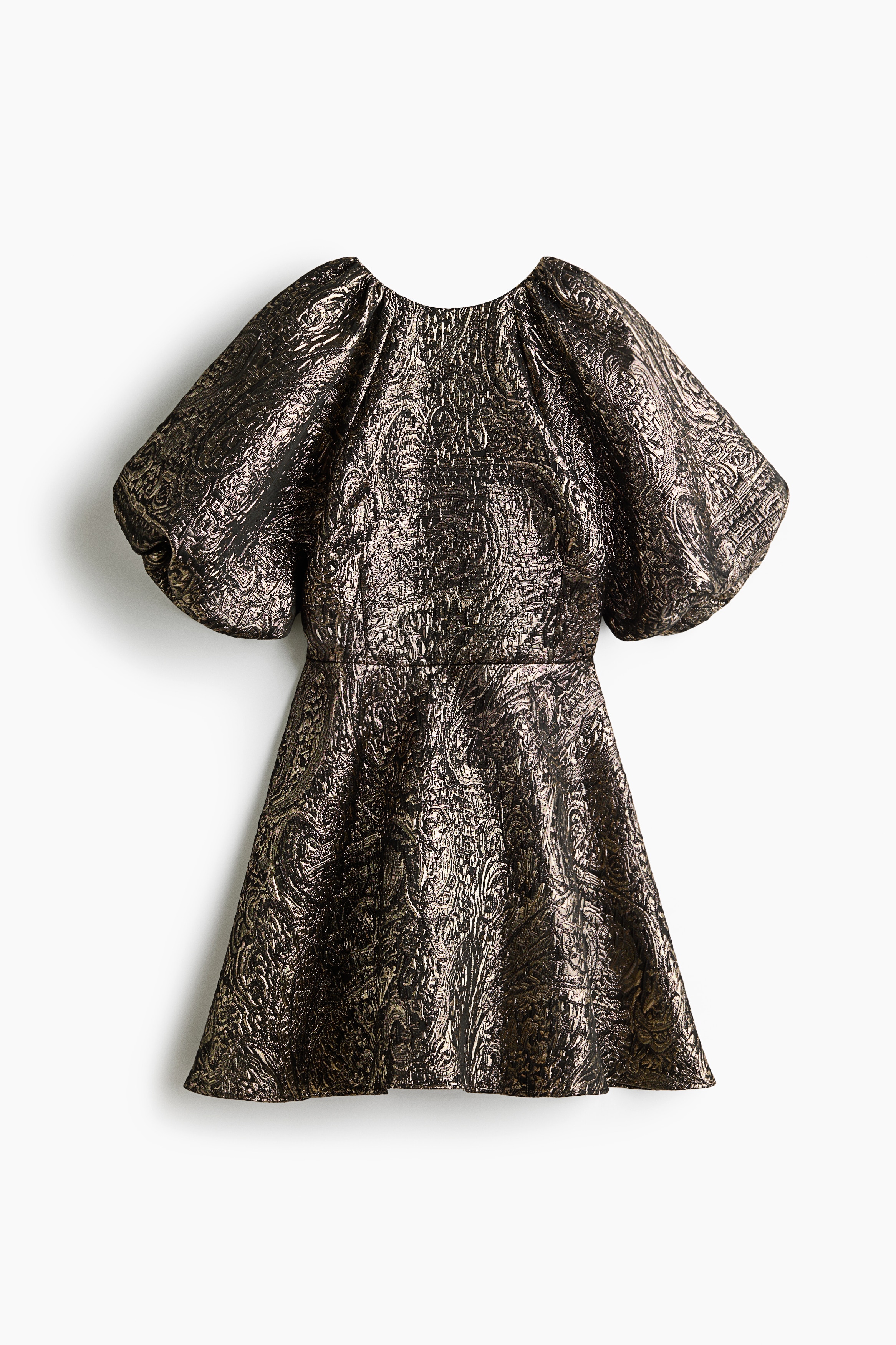 A short dress is presenting in a side profile, featuring a textured fabric with an intricate patterned weave, short puffed sleeves, and a cinched waist. A large black bow is detailing the upper back.
