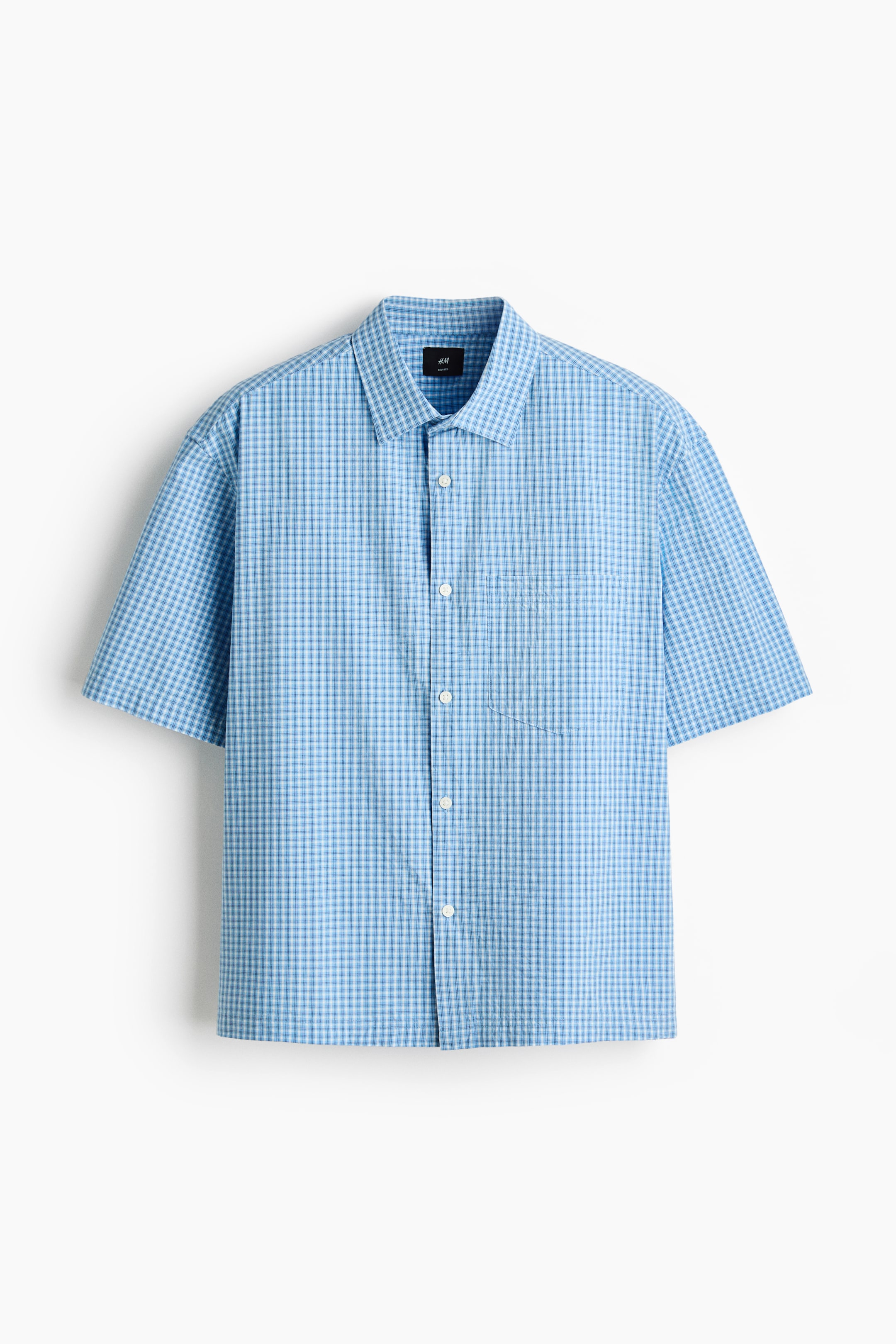 View larger image: A short-sleeved shirt showcases a blue and white gingham check pattern, presented facing front. It features a turn-down collar, a French front with white buttons, an open chest pocket on the left, a relaxed fit, and a straight-cut hem.
