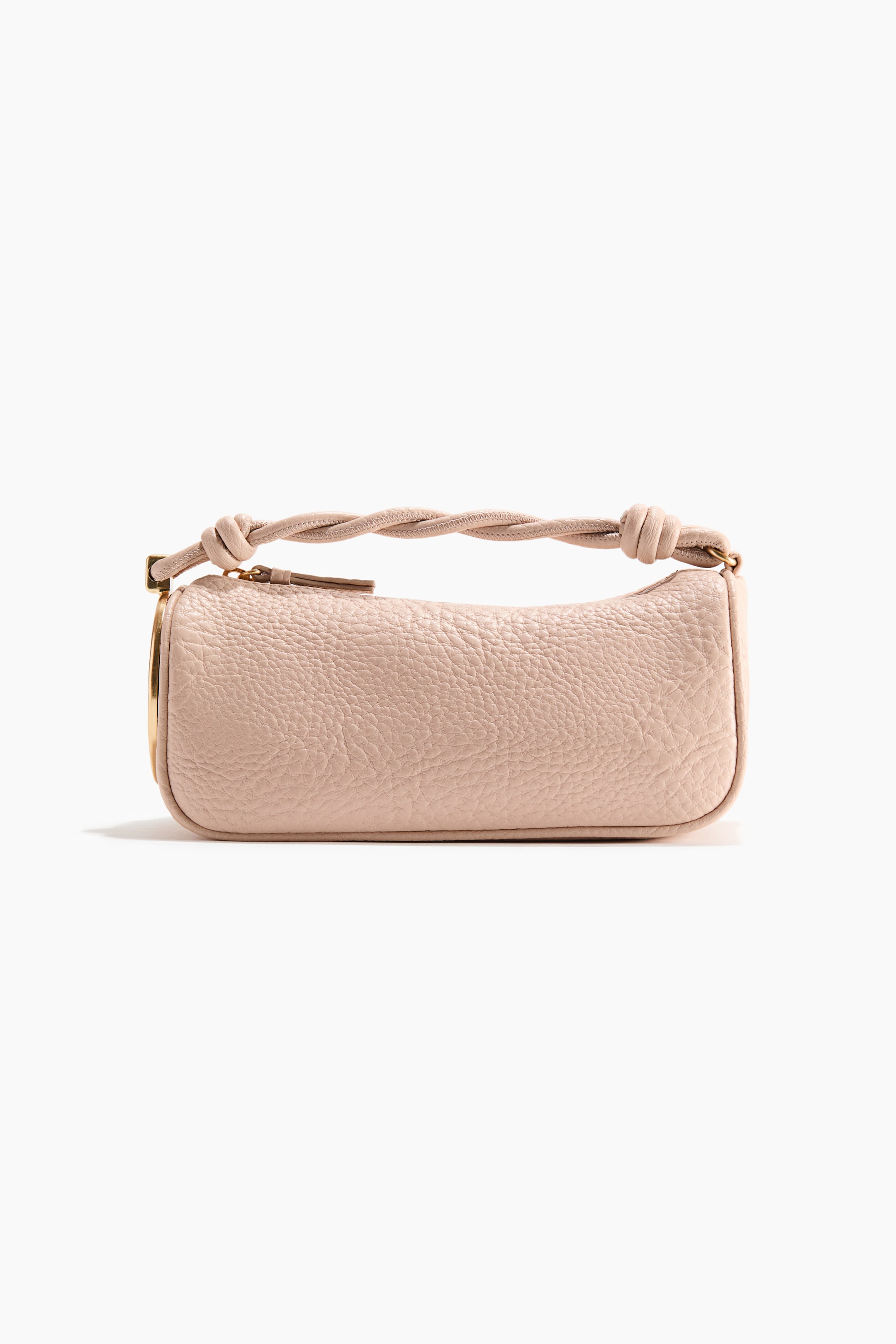 View larger image: A light pink handbag is showcased at the front, featuring a rectangular, barrel-shaped body crafted from pebbled leather. It is designed with a twisted top handle, knotted at each end, and displays gold-toned hardware.