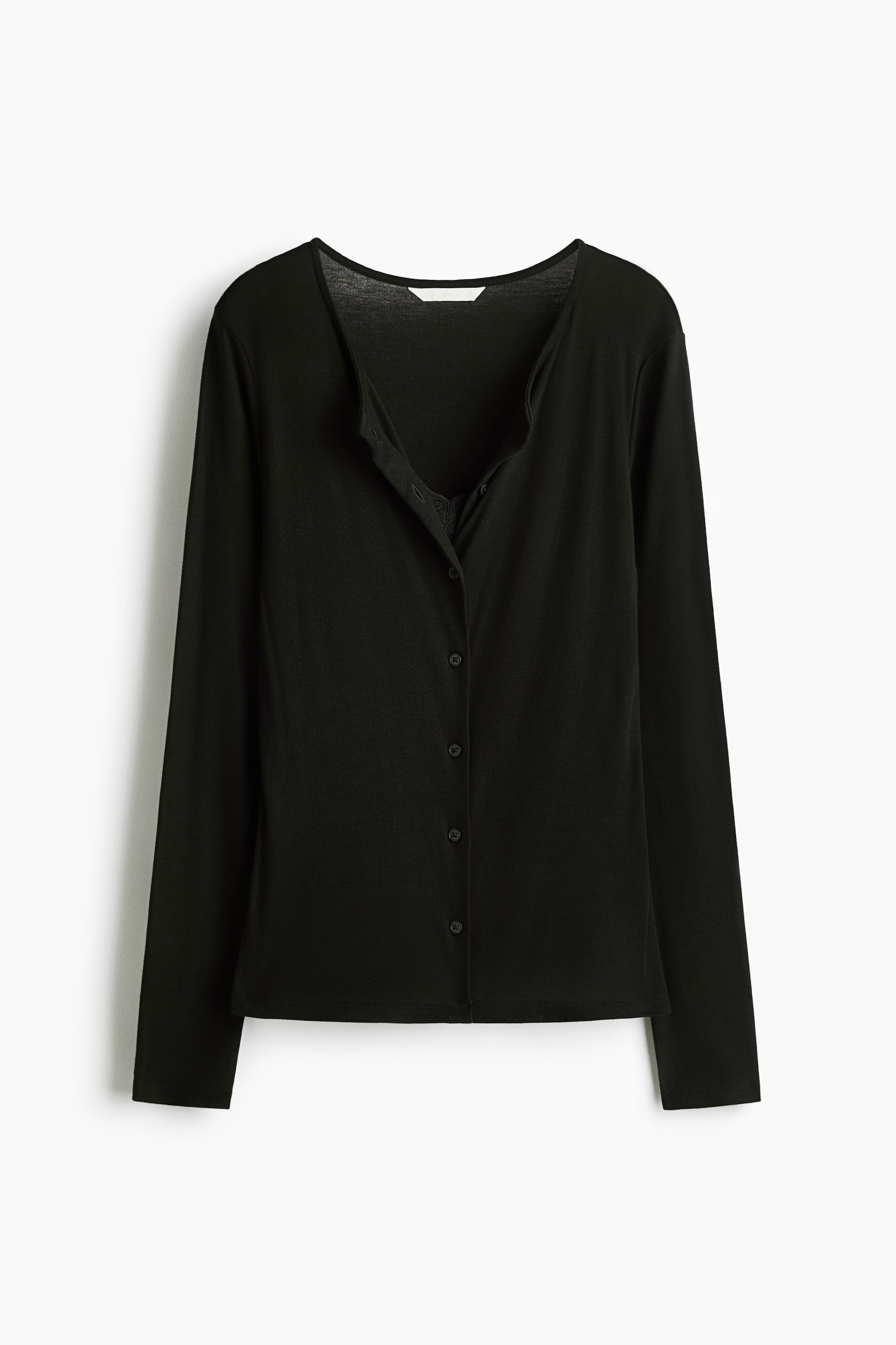 View larger image: A black fitted cardigan is shown from the front. It features a round neckline and buttons down the front. A sewn-in panel, resembling a strappy top with a lace-trimmed V-neckline, creates a layered appearance as the cardigan is unbuttoned at the top.
