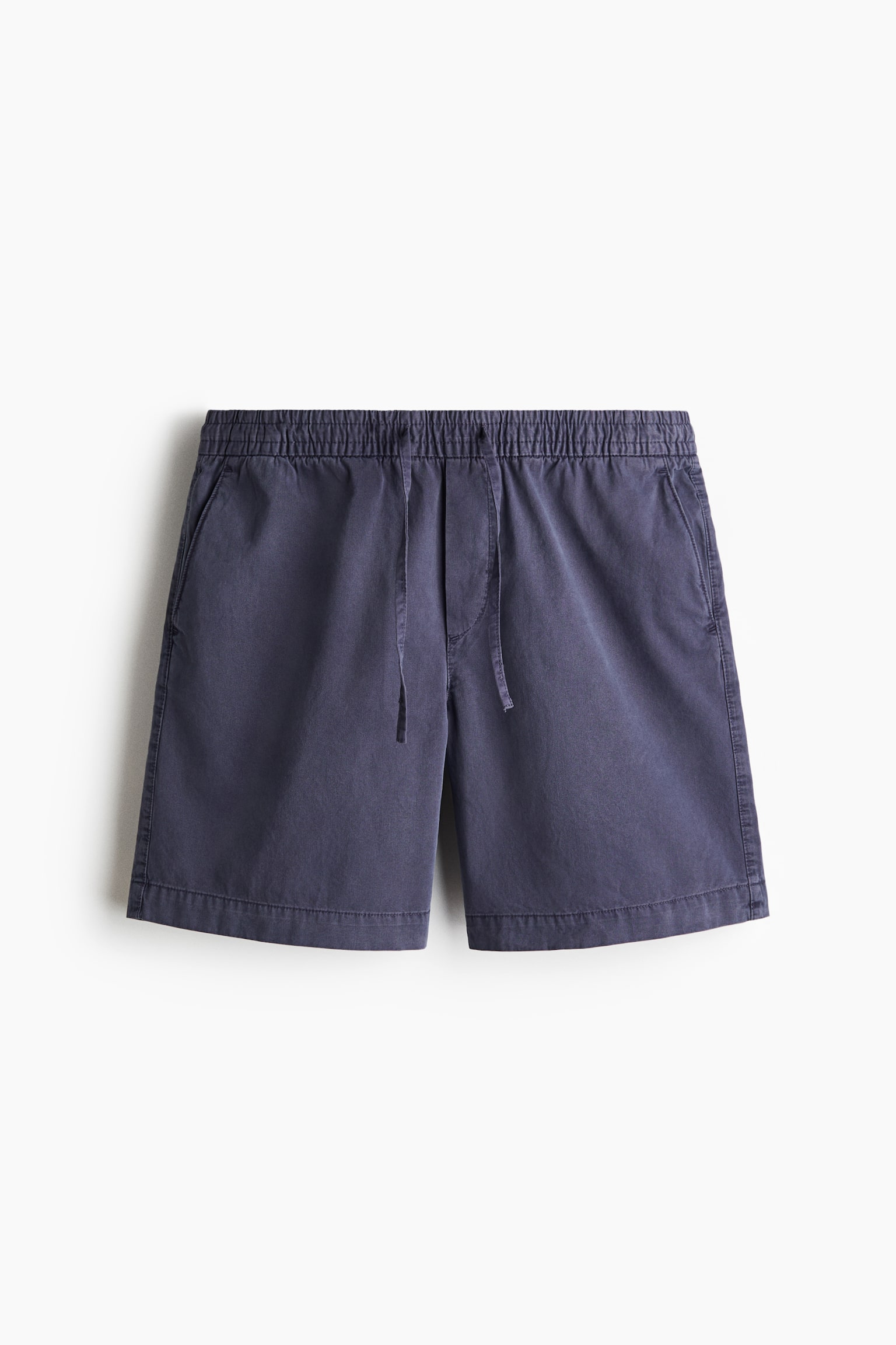 Dark blue cotton twill shorts are lying flat, displaying an elasticated drawstring waist with a visible knot, diagonal side pockets, and a fake fly. - 1