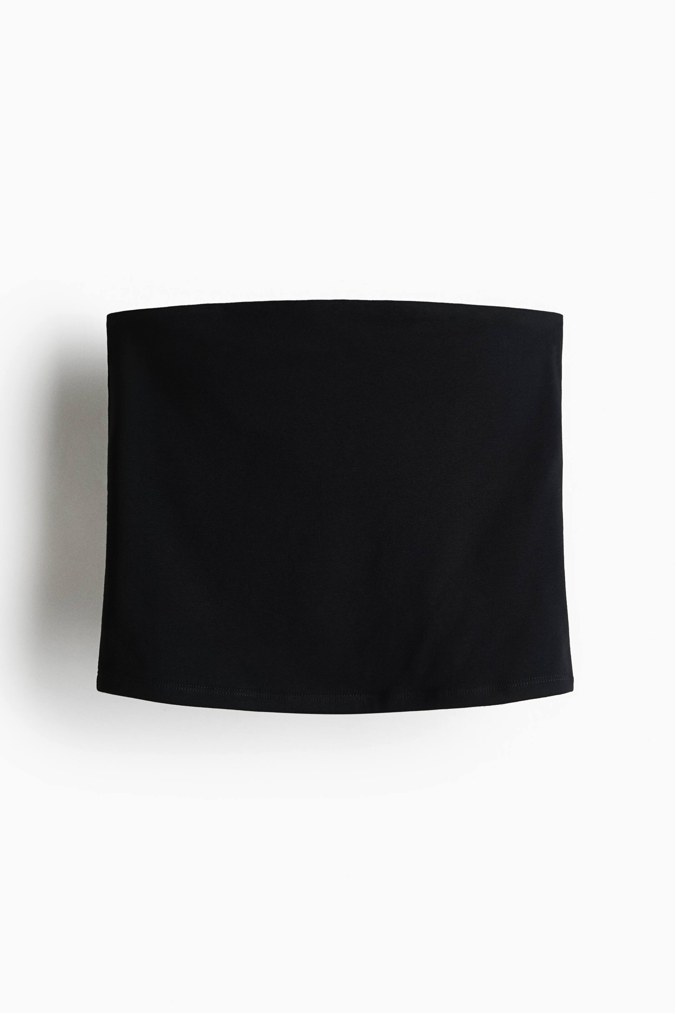 View larger image: A black strapless top is shown from the front, featuring a straight neckline and straight hem, creating a simple tube-style silhouette.
