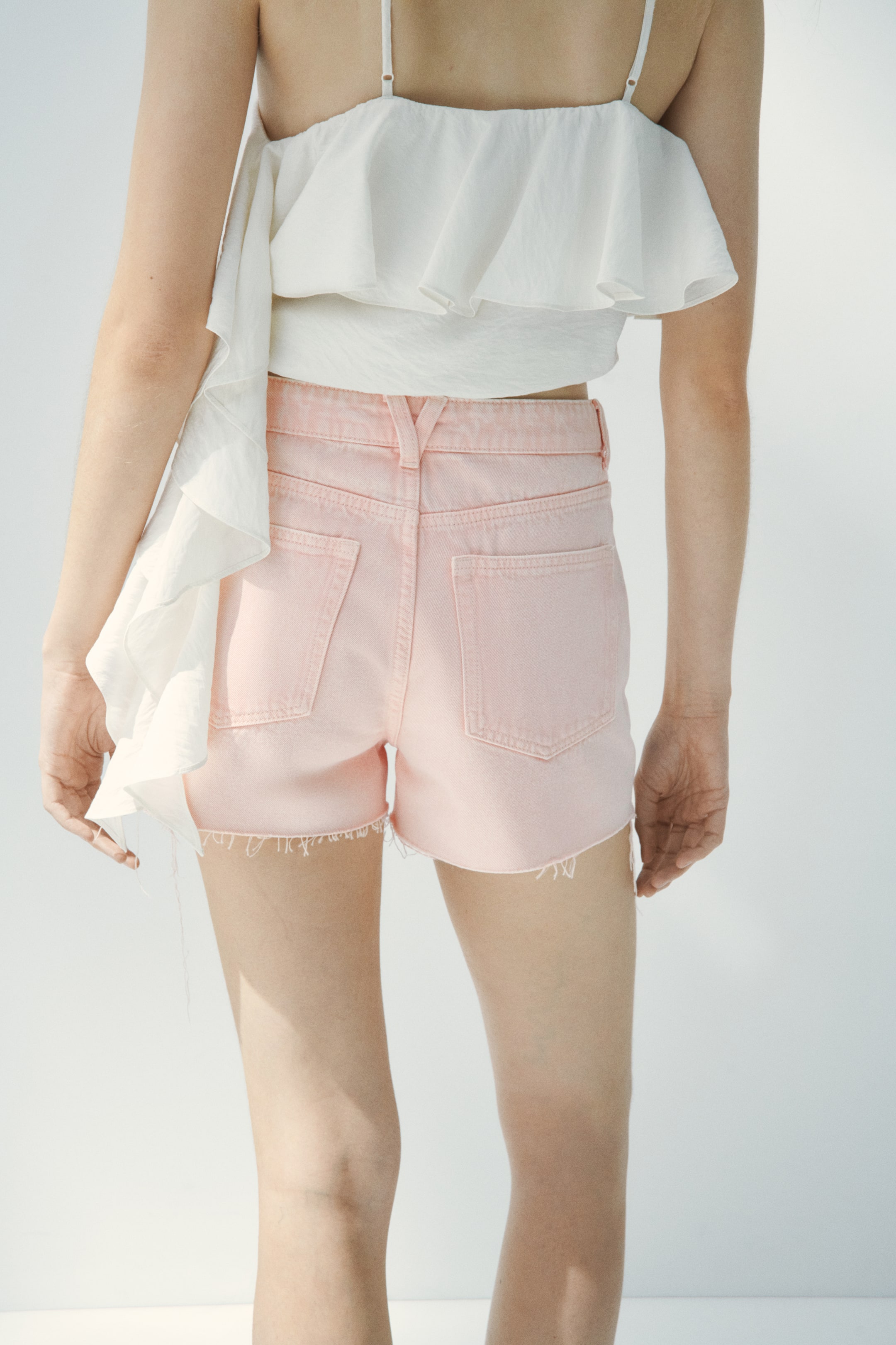 Raw-edge denim shorts