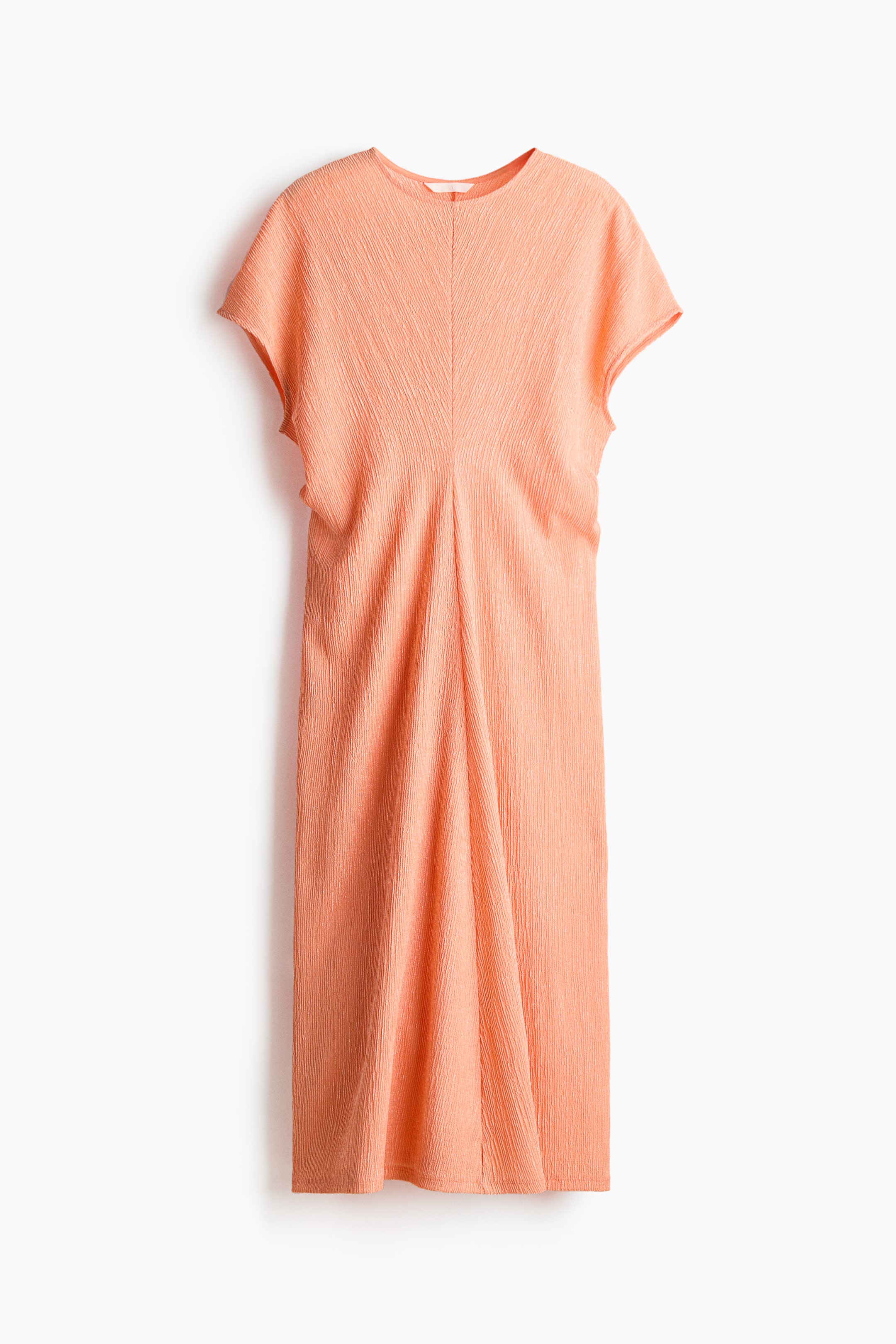 View larger image: A front-facing peach midi dress is showcasing a crinkled texture, a round neckline, and short sleeves. A prominent V-shaped seam is descending from the bodice, flowing into vertical pleats that are creating a relaxed, flowing silhouette.