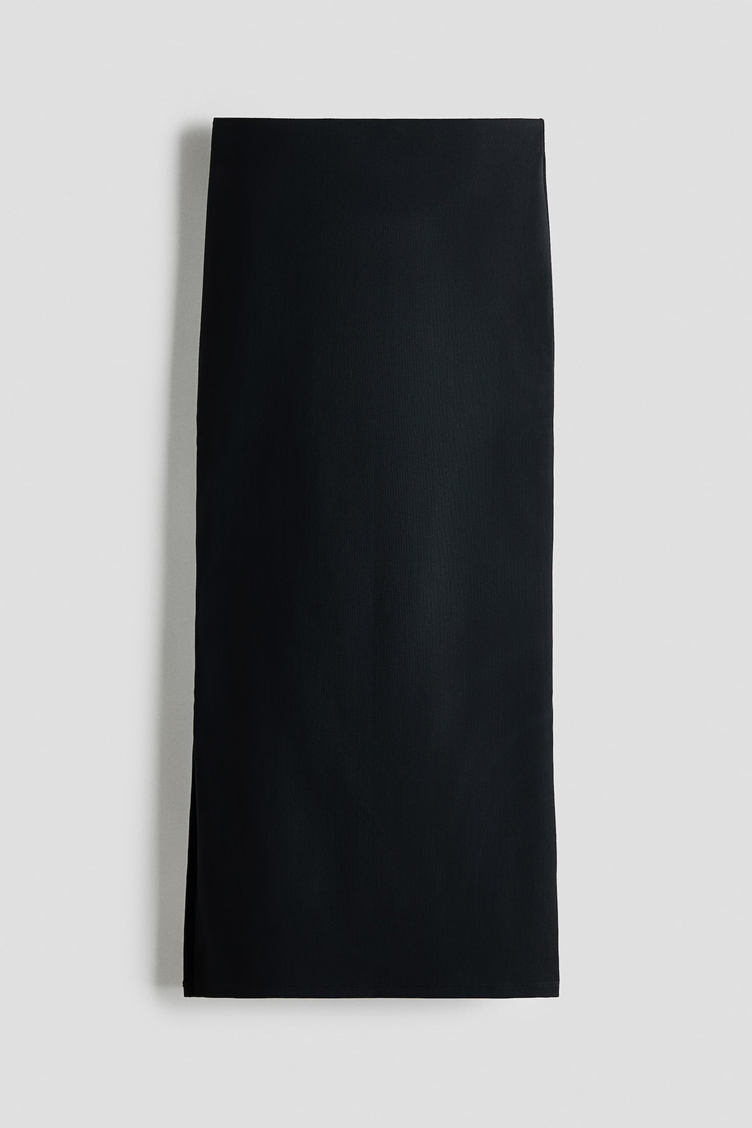 "A black pencil skirt is showcasing its front view, highlighting a sleek, subtly textured fabric, a long straight silhouette, and a short side slit opening on the left hem." - 1
