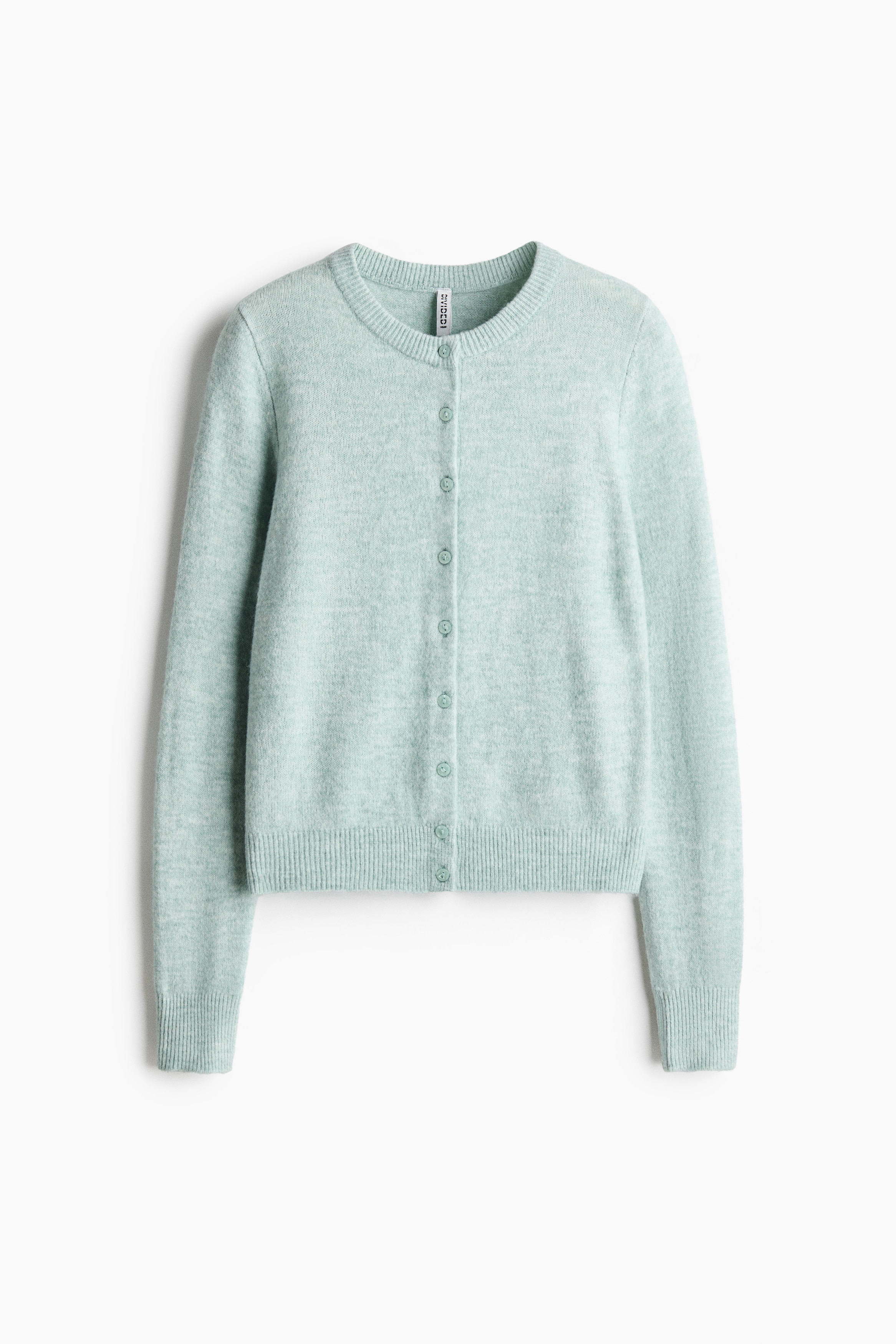 A light green, fitted knit cardigan featuring a round, rib-trimmed neckline, ribbed cuffs and hem, and a button-down front is being worn by the model. The cardigan is styled partially unbuttoned at the bottom over a white top and paired with wide-leg blue jeans.