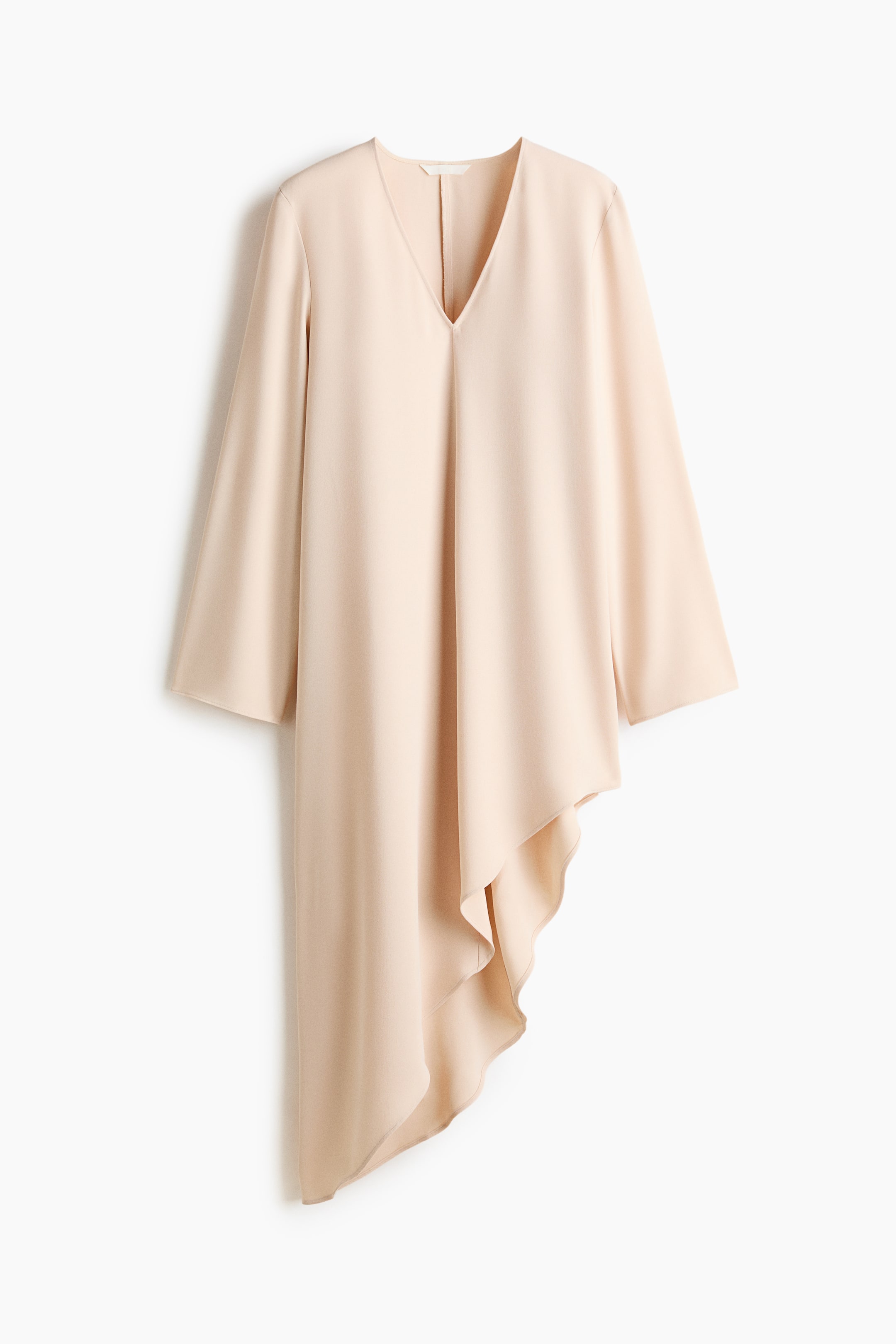 View larger image: A pale peach short dress in woven fabric features a deep V-neckline, long sleeves, and an asymmetric hem, and is unlined.
