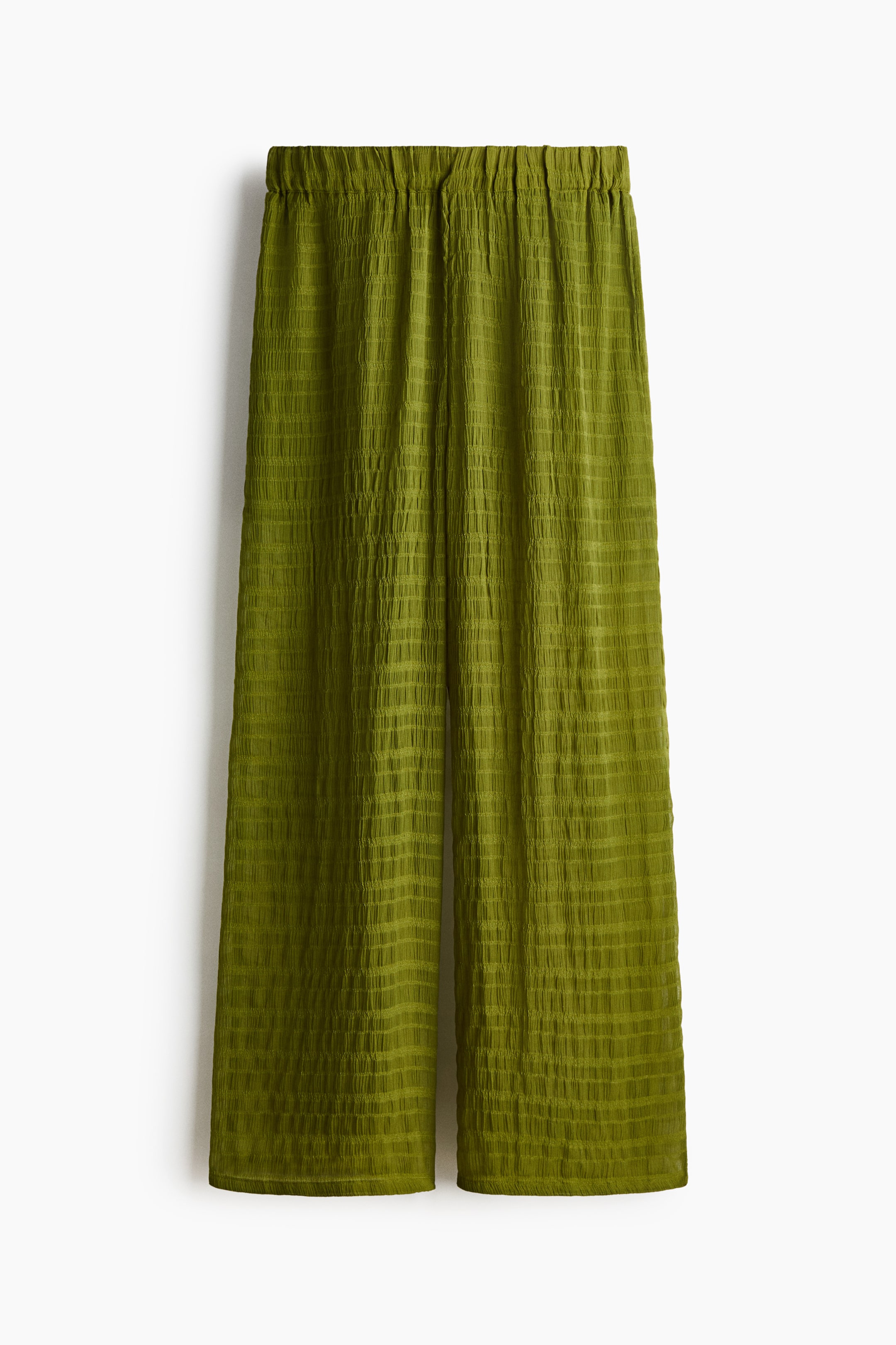 View larger image: "Green wide-leg trousers featuring an elasticated waistband and a crinkled, puckered texture forming a subtle grid pattern."