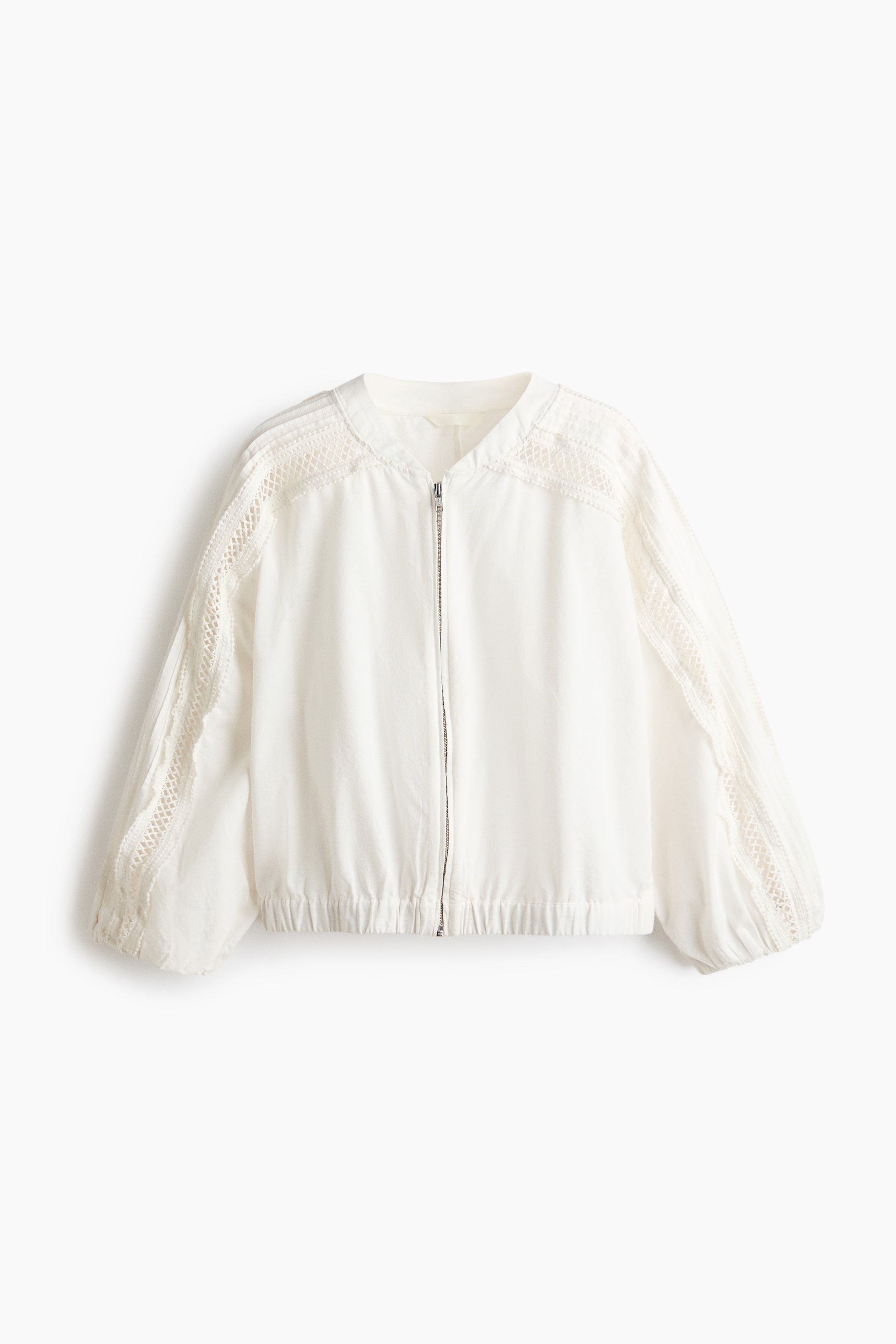 View larger image: "A white bomber jacket is displayed prominently, highlighting its front with a full-zip closure and a rounded, collarless neckline. The raglan sleeves are adorned with intricate lace panels along the shoulders and arms, and both the sleeve cuffs and bottom hem are elasticated."