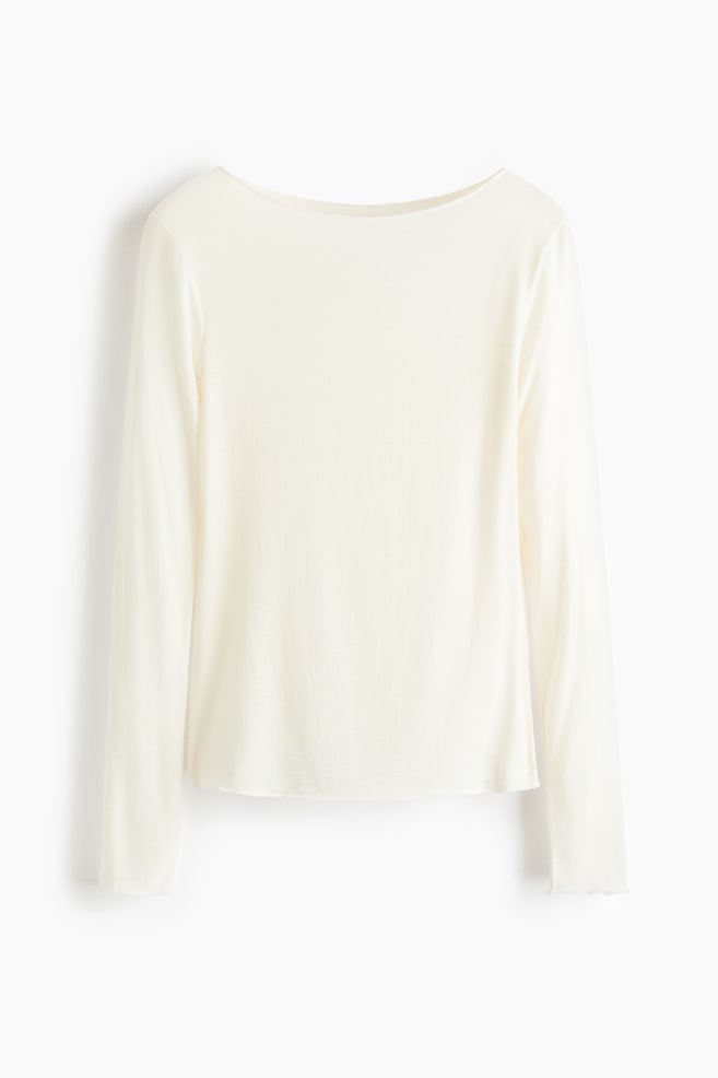 A cream-coloured long-sleeve top is shown from the front, featuring a wide boat neckline and a relaxed silhouette. The lightweight fabric drapes downward, finishing in a straight hem, with long, straight sleeves hanging at the sides. - 1