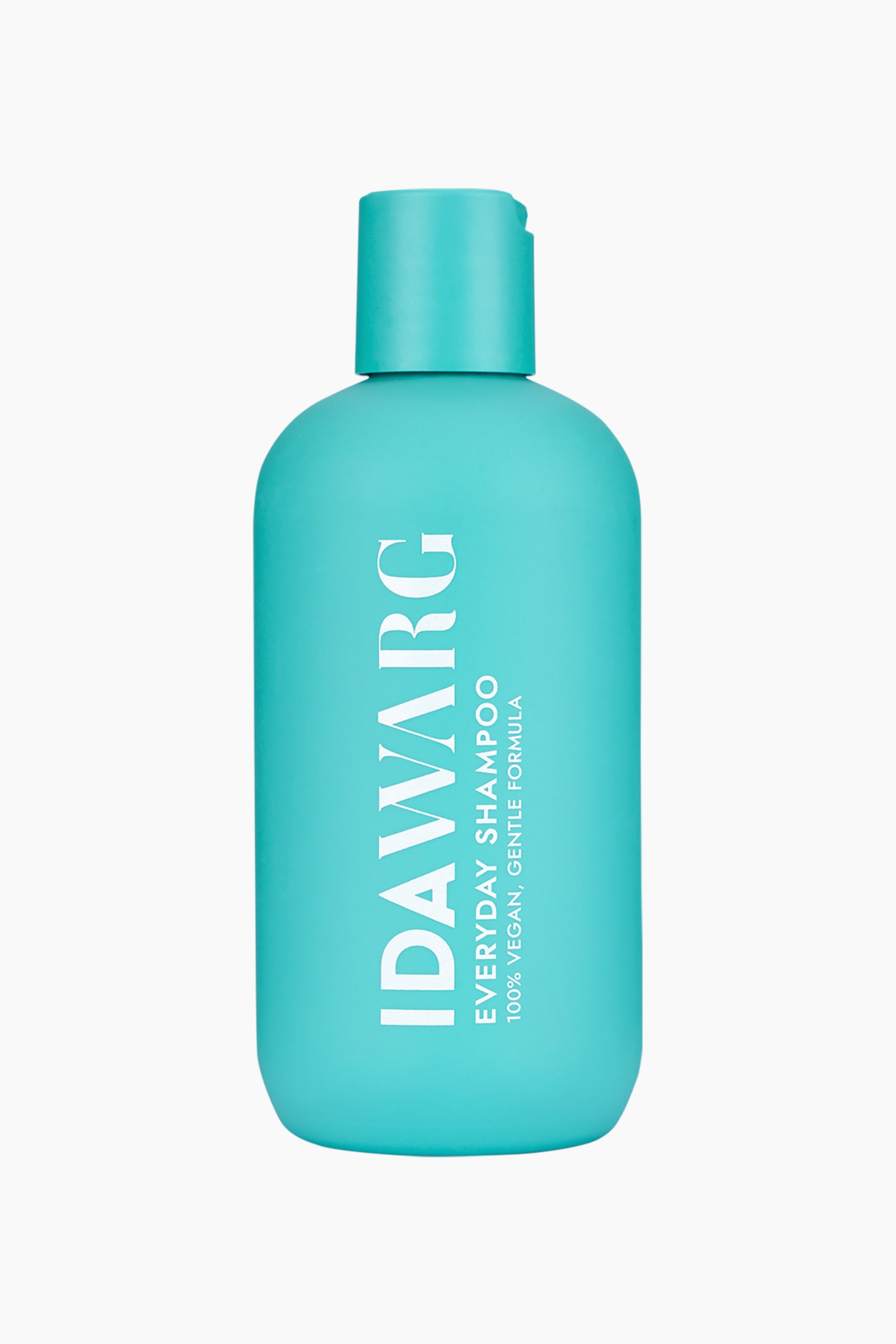 Visa större bild: En turkos schampoflaska står upprätt, vänd framåt, med en matchande flip-top-kork. Vit text på framsidan visar "IDAWARG" vertikalt och "EVERYDAY SHAMPOO, 100% VEGAN, GENTLE FORMULA" horisontellt.