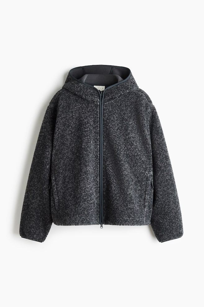 A dark grey teddy fleece hooded jacket is shown from the front, featuring a relaxed fit and a full-length, two-way front zipper. The jacket has long sleeves with narrow elasticated cuffs and a hood with a smooth, dark grey interior lining. - 1