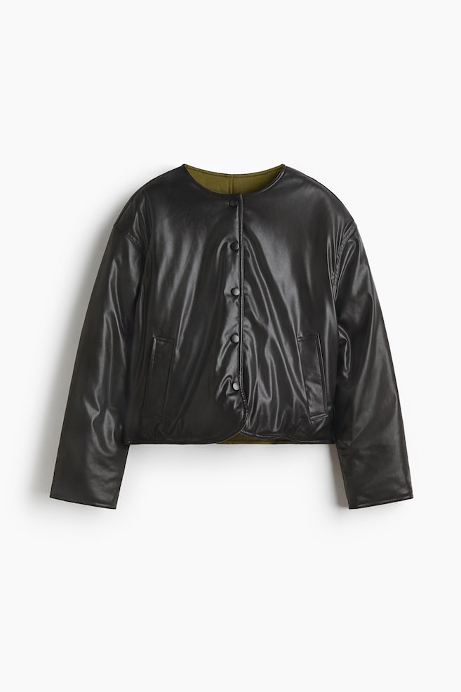A dark leather-look jacket is being displayed in a FRONT view, featuring a collarless neckline and a front button closure with dark buttons. Two patch pockets are detailing the front, and an olive green ribbed lining is peeking out at the collar and hem. - 1