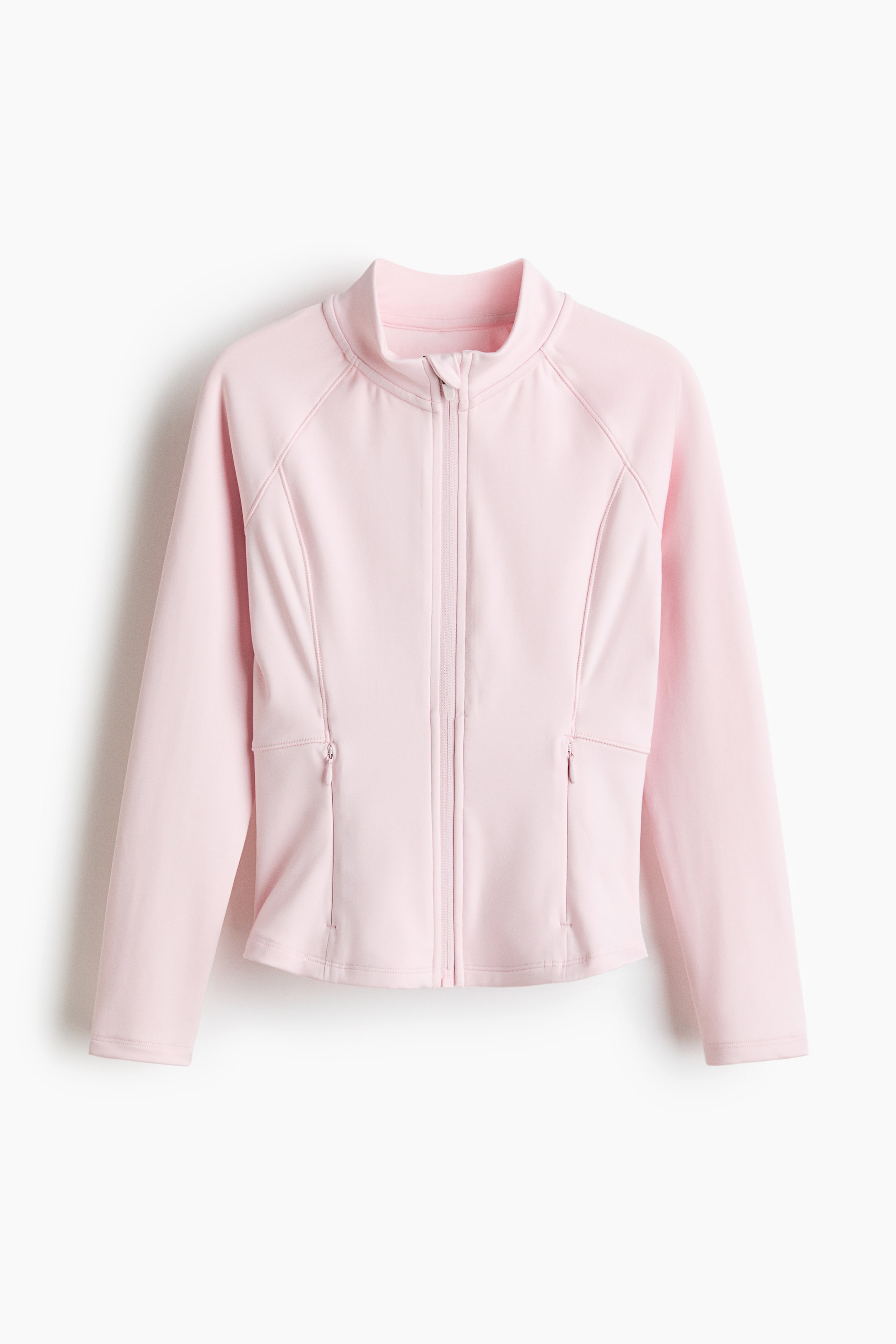 Größeres Bild ansehen: Eine hellrosa Sportjacke mit DryMove zeigt ihre VORDERSEITE und verfügt über einen durchgehenden Reißverschluss, einen Stehkragen, sichtbare Raglan-Nähte und zwei Reißverschlusstaschen auf Taillenhöhe.