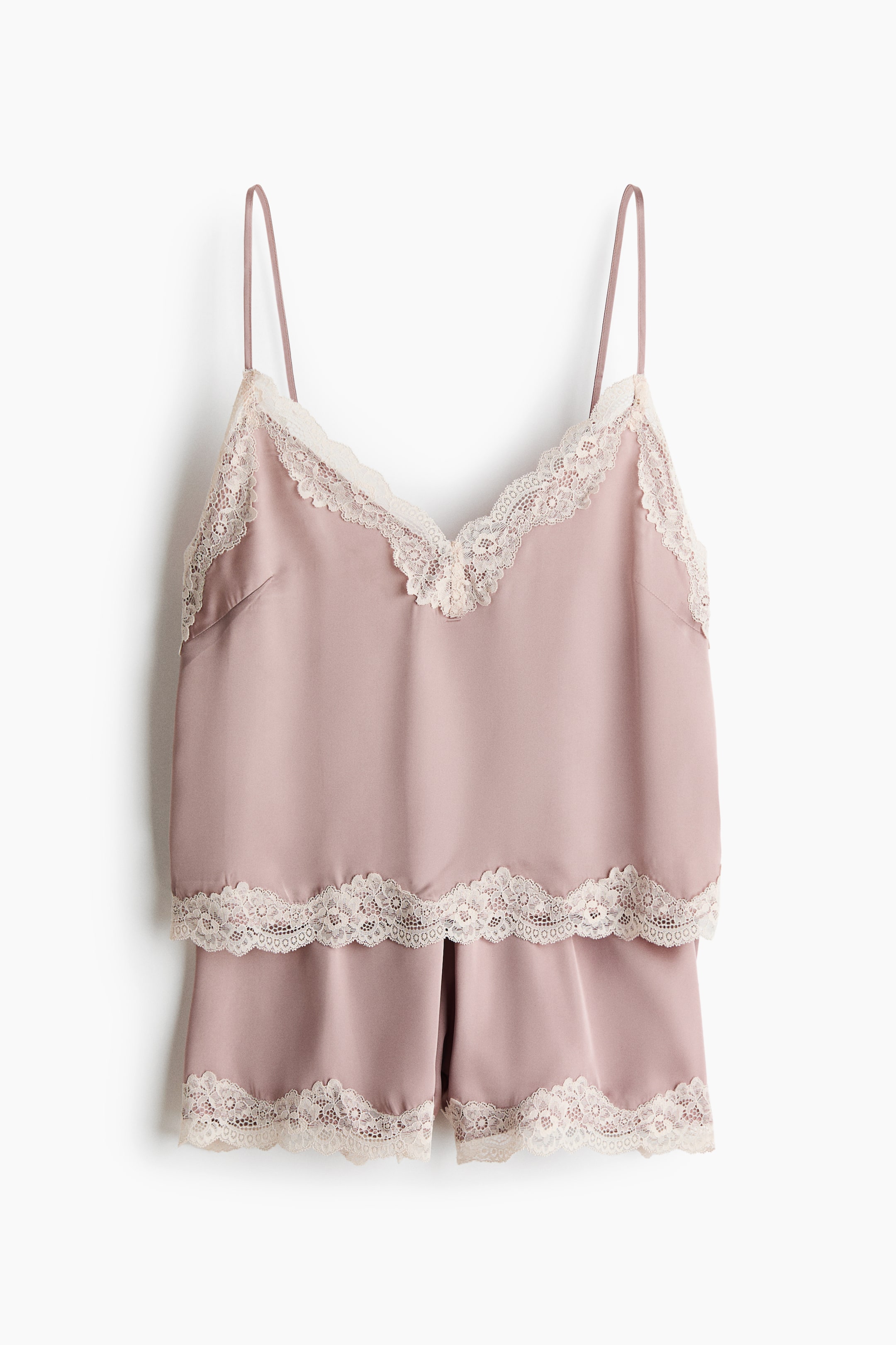 View larger image: A set of pyjamas is displayed from the front, comprising a strappy top and shorts in softly draping satin. The top showcases spaghetti shoulder straps and a V-shaped neckline, both adorned with lace trims, while the shorts feature covered elastication at the waist and matching lace along the hems.