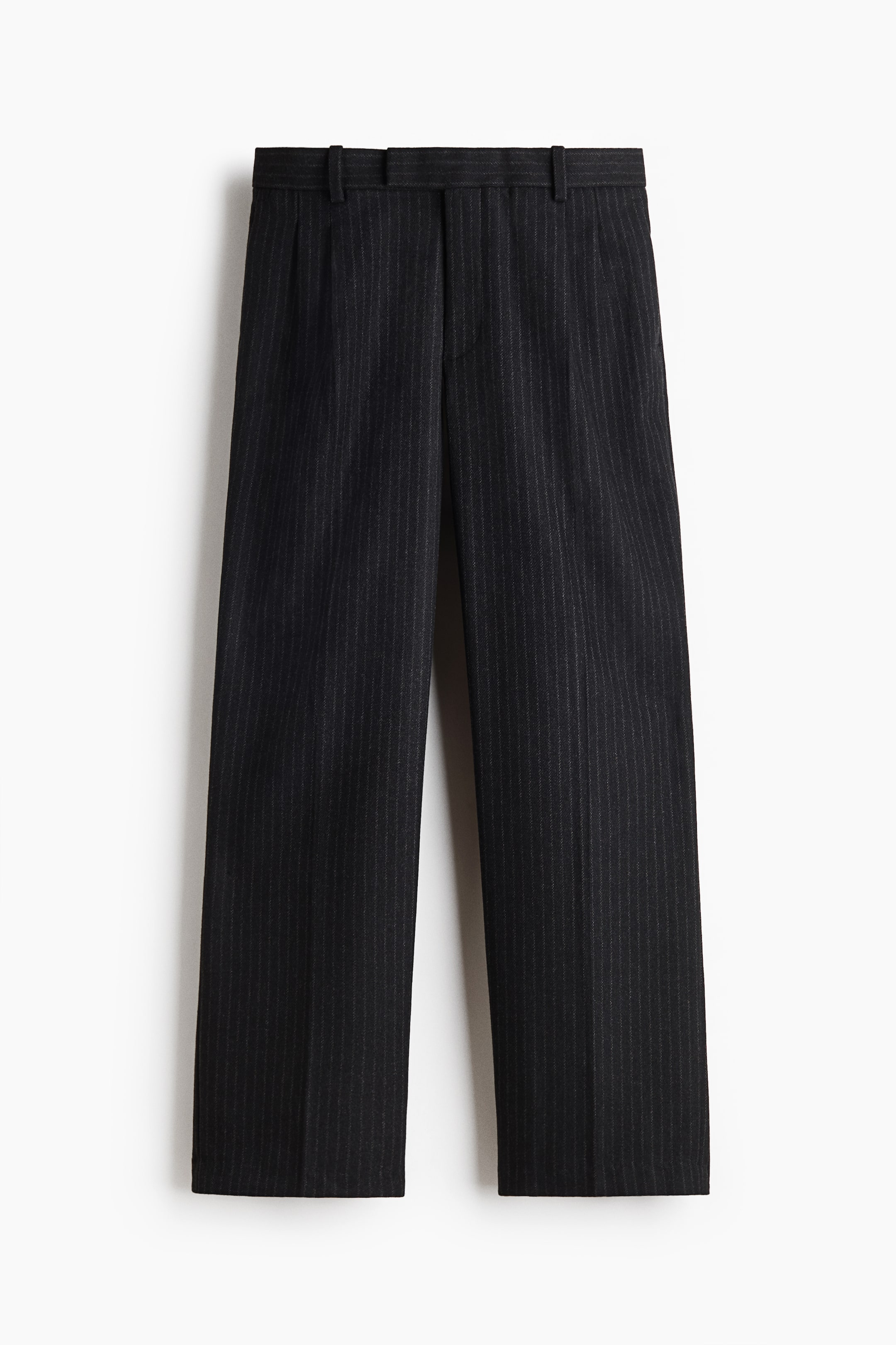 View larger image: A pair of dark grey pinstripe trousers is hanging front-facing, showcasing a straight-leg silhouette with sharp creases running down the centre of each leg. The trousers feature a structured waistband with belt loops and a clean, concealed front closure.