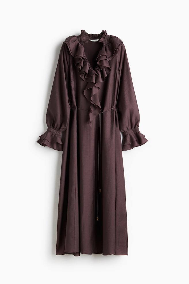 A FRONT view of an ankle-length dress in a woven fabric is featuring a V-neckline, a frilled stand-up collar, and double-layered ruffles framing the neckline and extending to the waist. A detachable spaghetti tie belt is cinching the waist, and the dress is presenting long, raglan balloon sleeves with frill-trimmed, buttoned cuffs. - 1